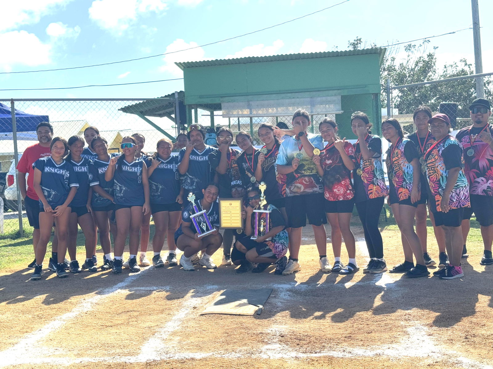 Mount Carmel School and Tanapag Middle School players pose for a group photo with their trophies during the awards ceremony in the girls high school division of the PSS-NMISA Interscholastic Fast Pitch Softball League at the Dandan softball field on Saturday.Photos by James F. Sablan Jr.