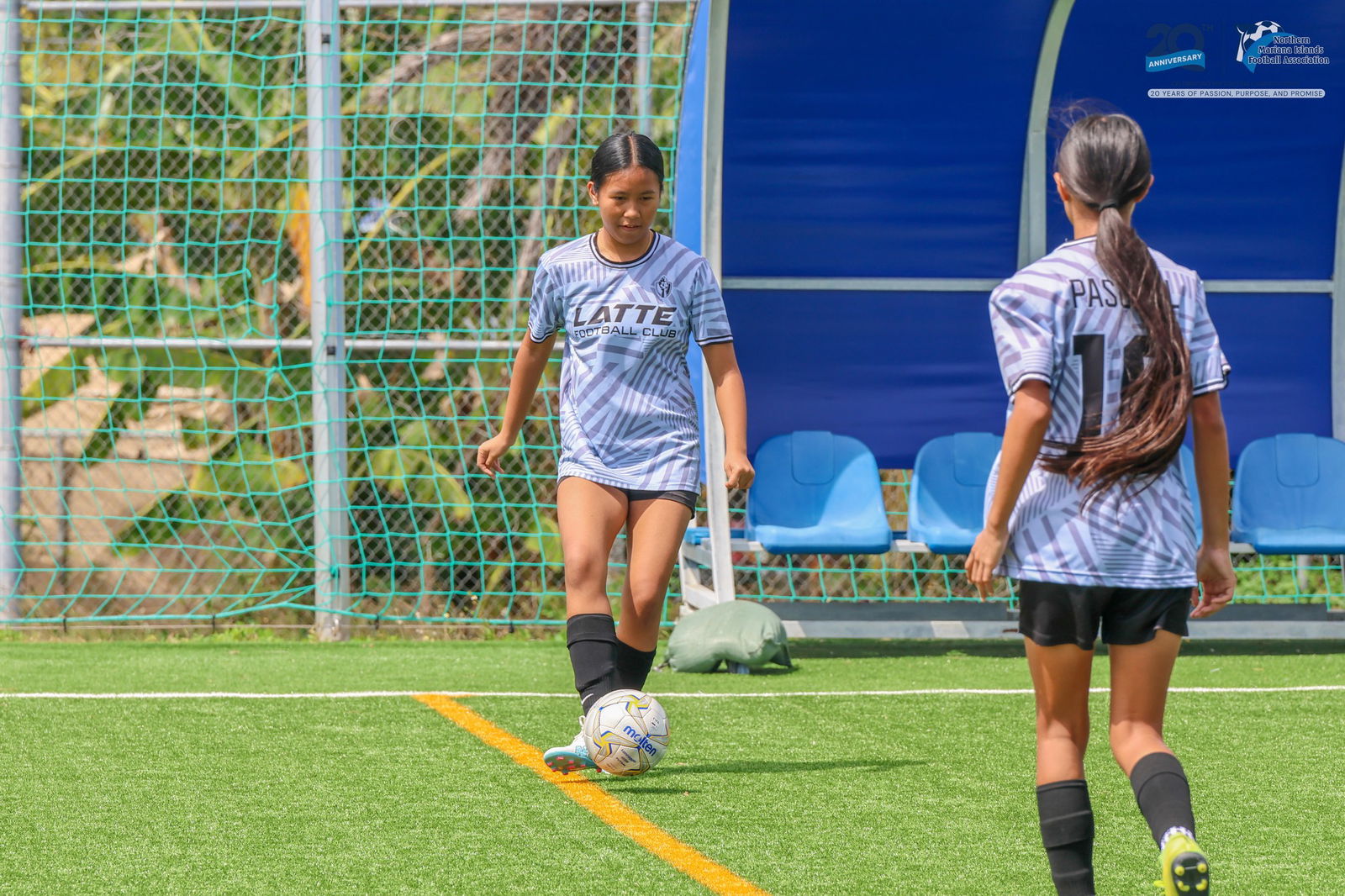 Latte Football Club's Phangwadee Claridades passes to her teammate Xyriel Pascual during a U14 girls division game of the TakeCare Youth Soccer League Spring 2025 at the NMI Soccer Training Center in Koblerville.Photo by NMIFA