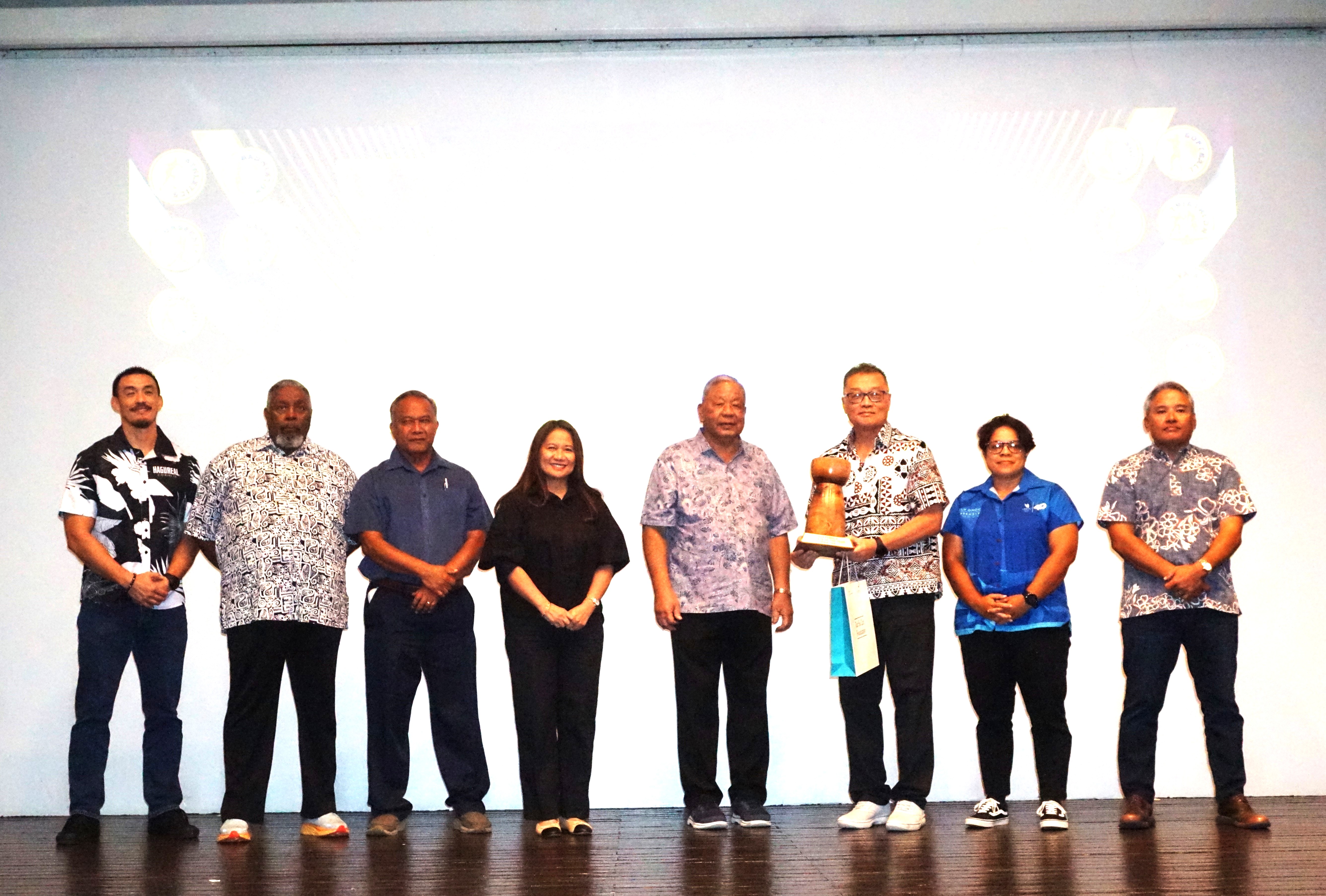 Jerry Tan, father of Tania Tan, accepts the Female Athlete of the Year award on her behalf as he poses for a photo with other NMSA officials during the Northern Marianas Sports Association annual awards banquet and 40th anniversary celebration at the Taga Hall of Crowne Plaza Resort Saipan on Thursday.