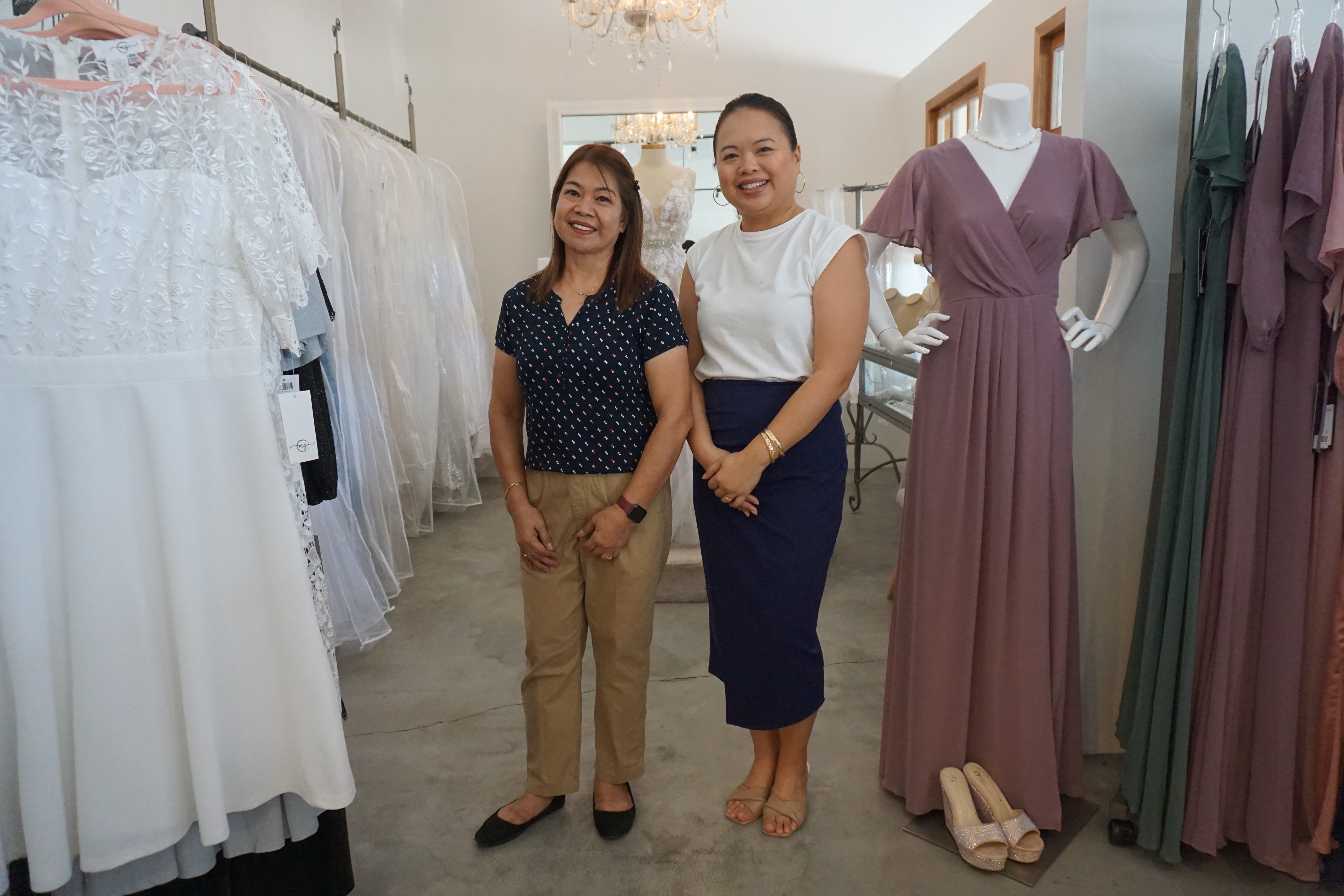 Rossie Abadilla, sales associate, left, stands with Michelle Sablan, inside Pena House.