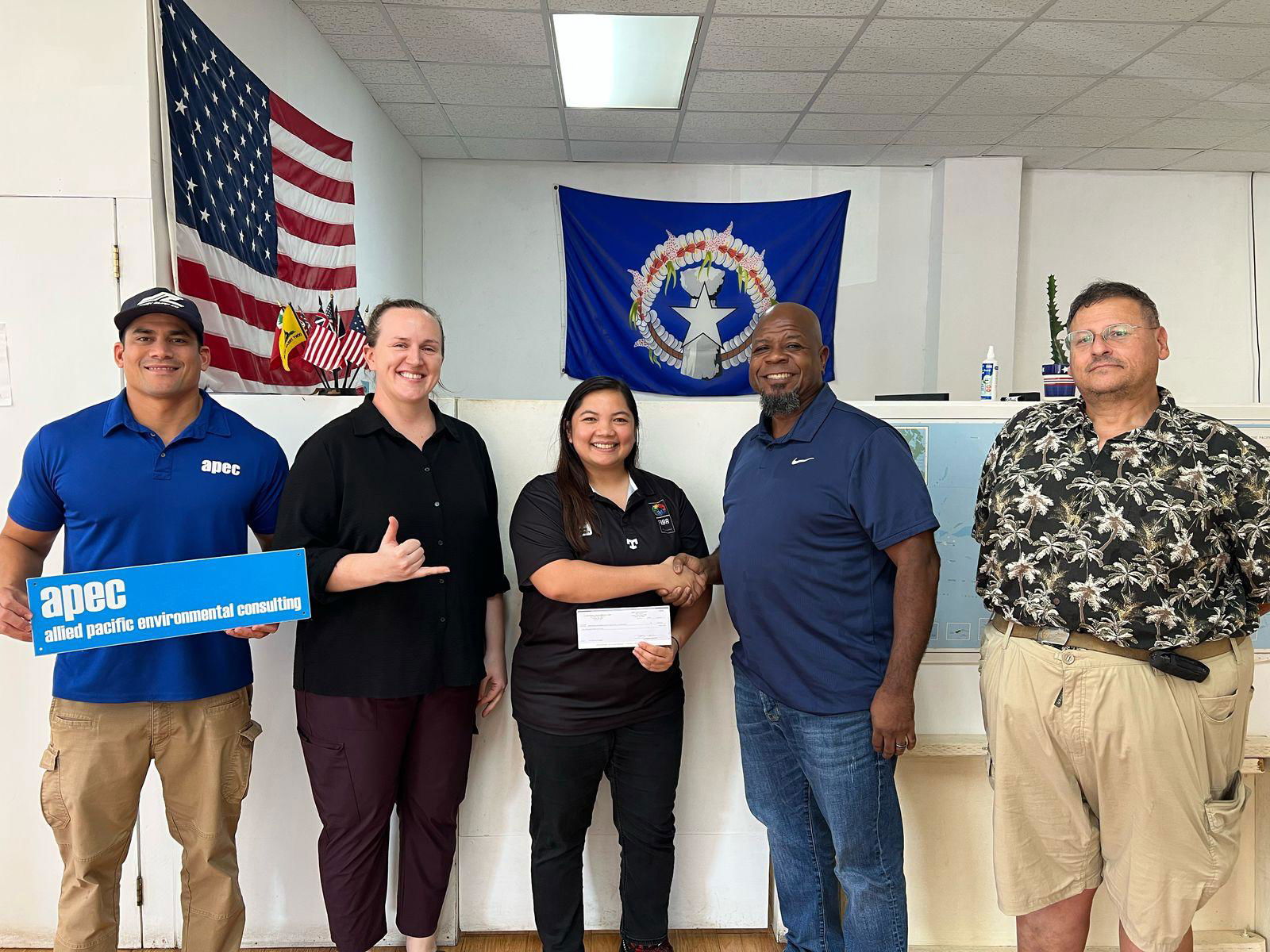 Marlene Lumabi, center, poses for a photo with Allied Pacific Environmental Corporation's Edward Manibusan, Rachel Langu, Joshua Gray, and David Radich on March 7 at the APEC office. APEC donated a $2,000 check as a sponsor of the upcoming 2025 Allied Pacific Environmental Corporation Basketball League.Contributed photo