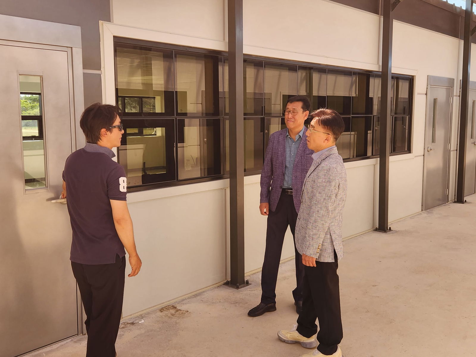 From, CJ Innovation engineer Kim Jung Hoon, executive director Jee Young Su and vice president Park Byoung Eok visit the newly installed modular school building at Admiral Herbert G. Hopwood Middle School on Monday.Contributed photo