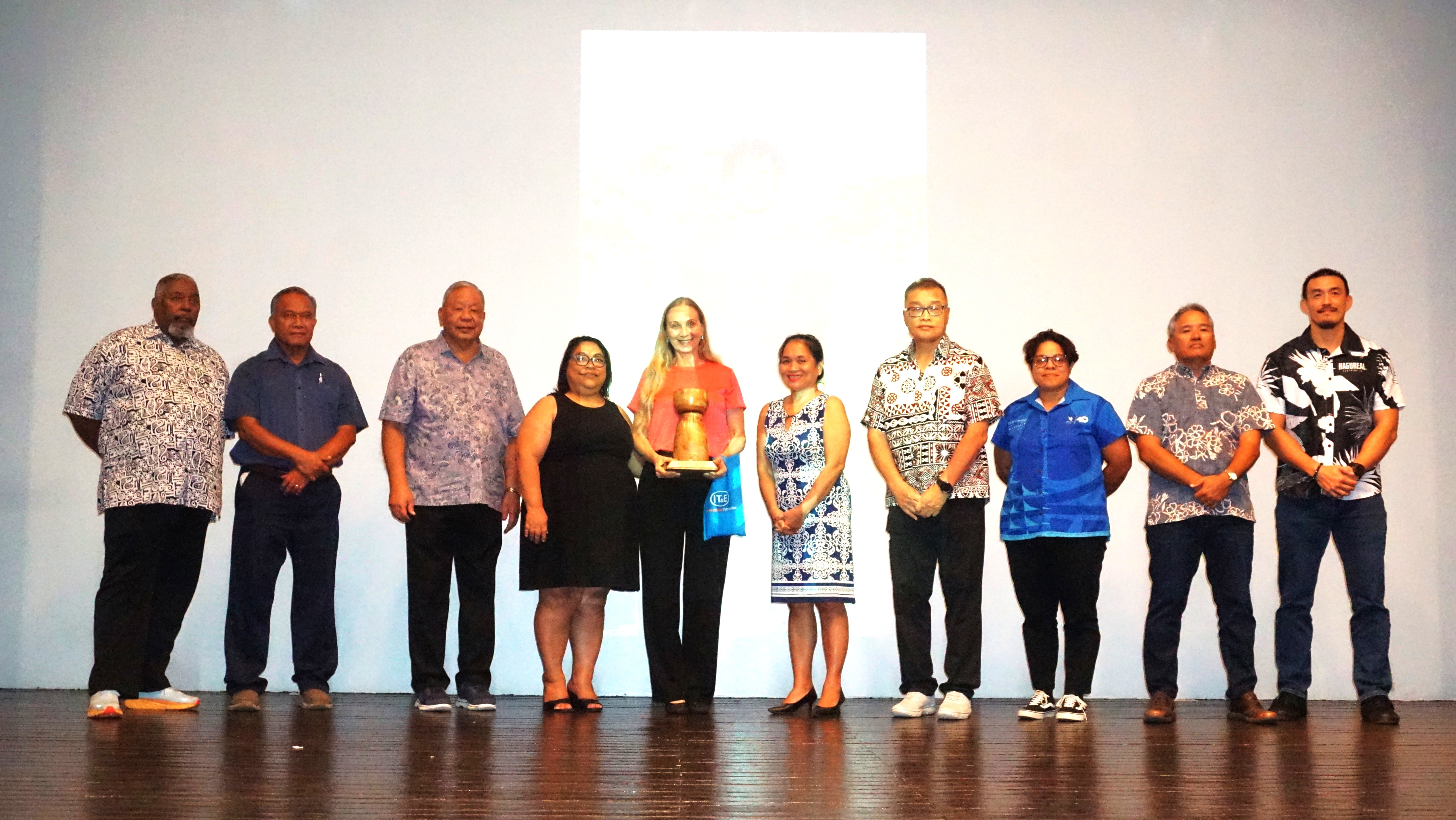 Yulia Aleksenko, mother of Isaiah, poses with his Male Student Athlete of the Year trophy alongside NMSA officials during the Northern Marianas Sports Association annual awards banquet and 40th anniversary celebration at the Taga Hall of Crowne Plaza Resort Saipan on Thursday.