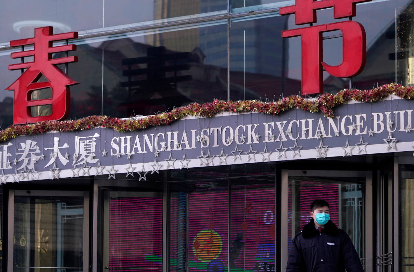 A security guard stands at the Shanghai Stock Exchange building at the Pudong financial district in Shanghai, China on Feb. 3, 2020.REUTERS