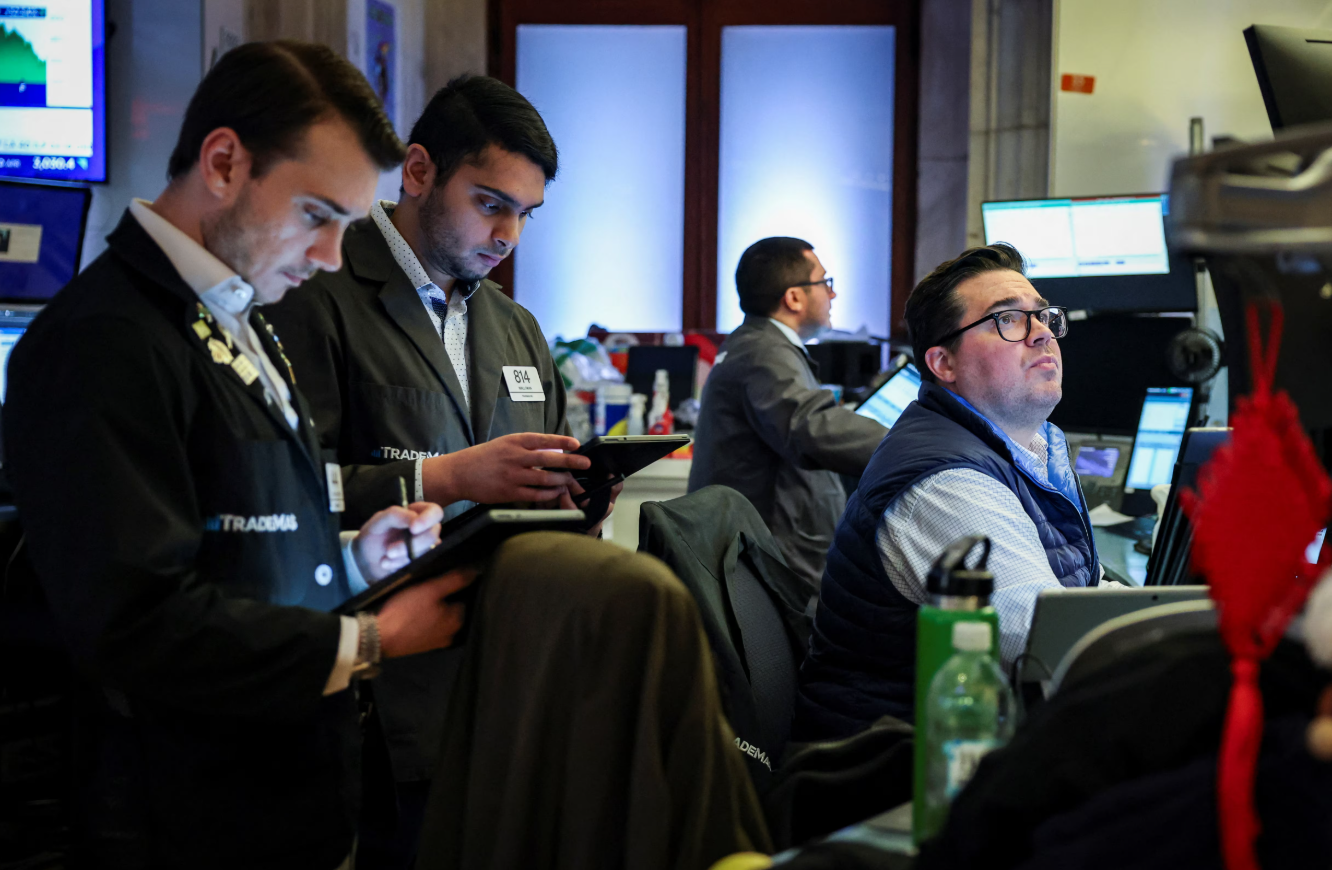 Traders work on the floor at the New York Stock Exchange in New York City, March 24, 2025.