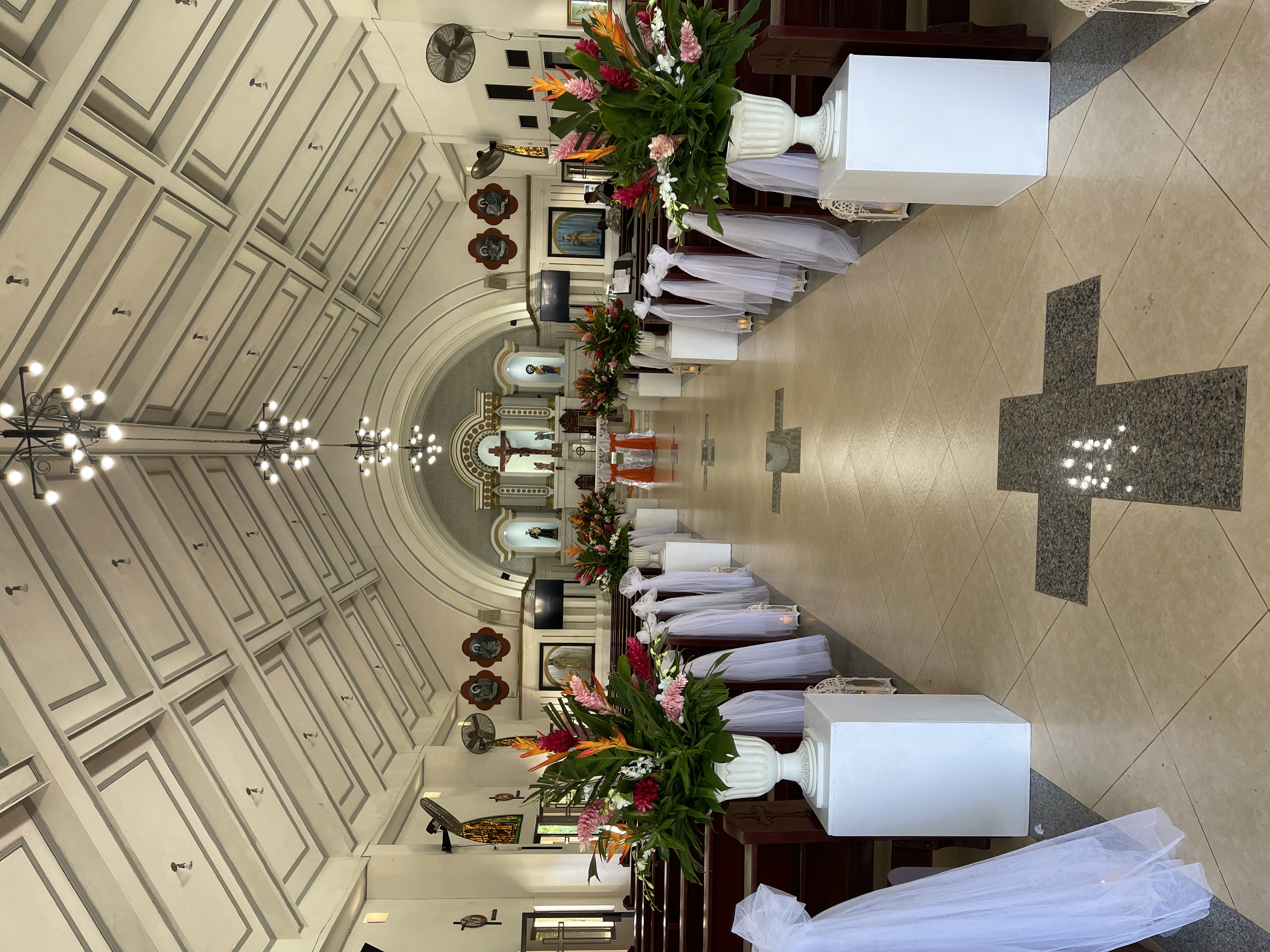 The interior of this church is beautifully lined with floral arrangements and sashes, courtesy of Philip Canuto of Island Touch