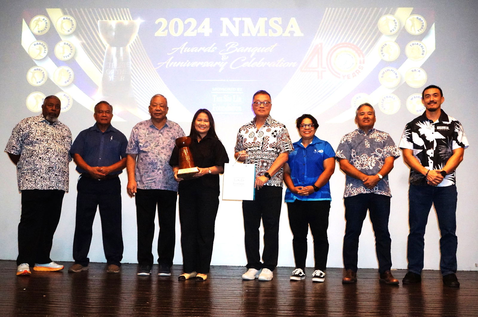 Administrator of the Year awardee Merlie Tolentino poses for a photo with Lt. Gov David Apatang and the Northern Marianas Sports Association board members during the NMSA annual awards banquet and 40th anniversary celebration at the Taga Hall of Crowne Plaza Resort Saipan on Thursday.