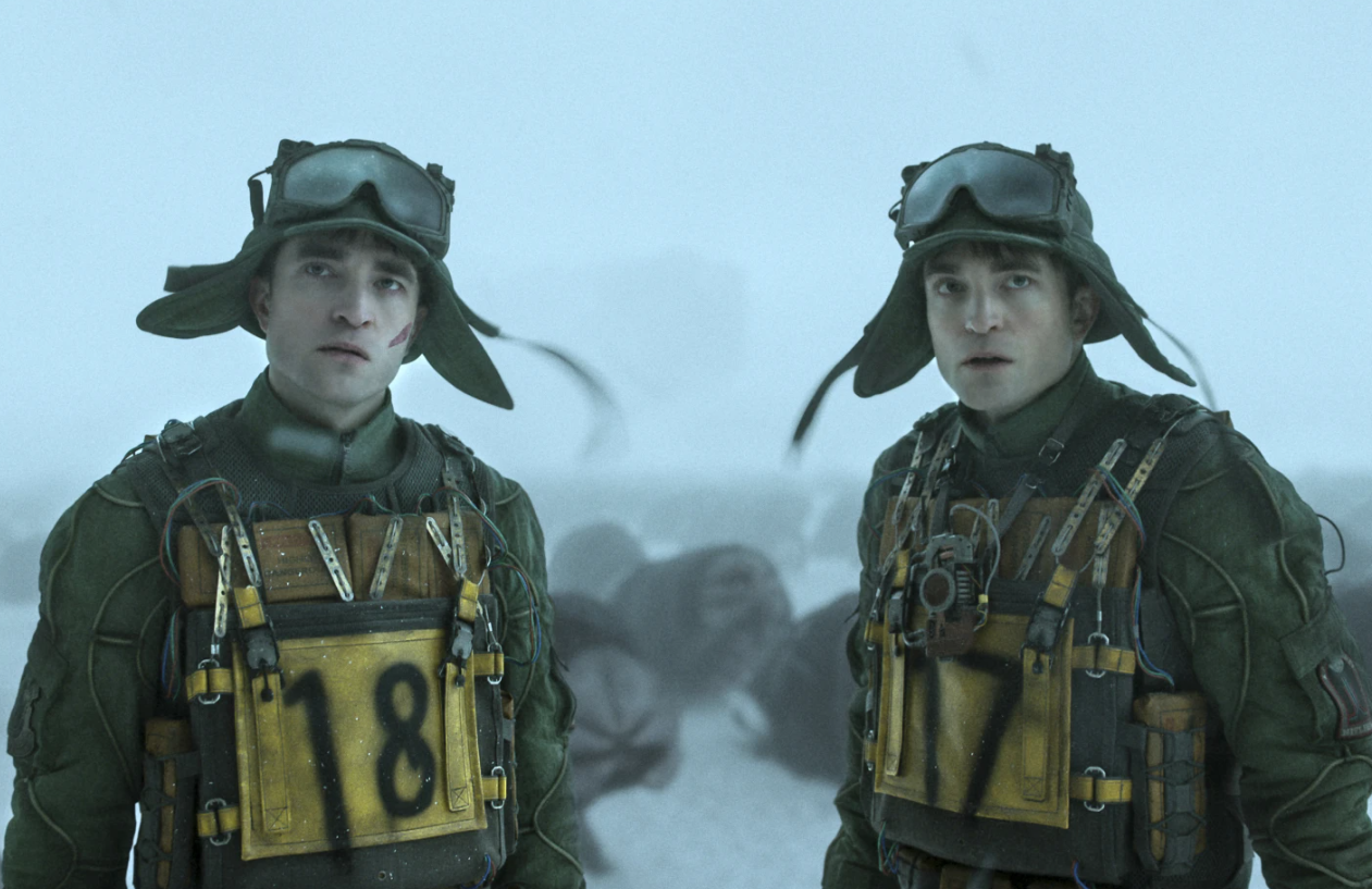 Robert Pattinson as Mickey 18, left, and Mickey 17 in a scene from “Mickey 17.”