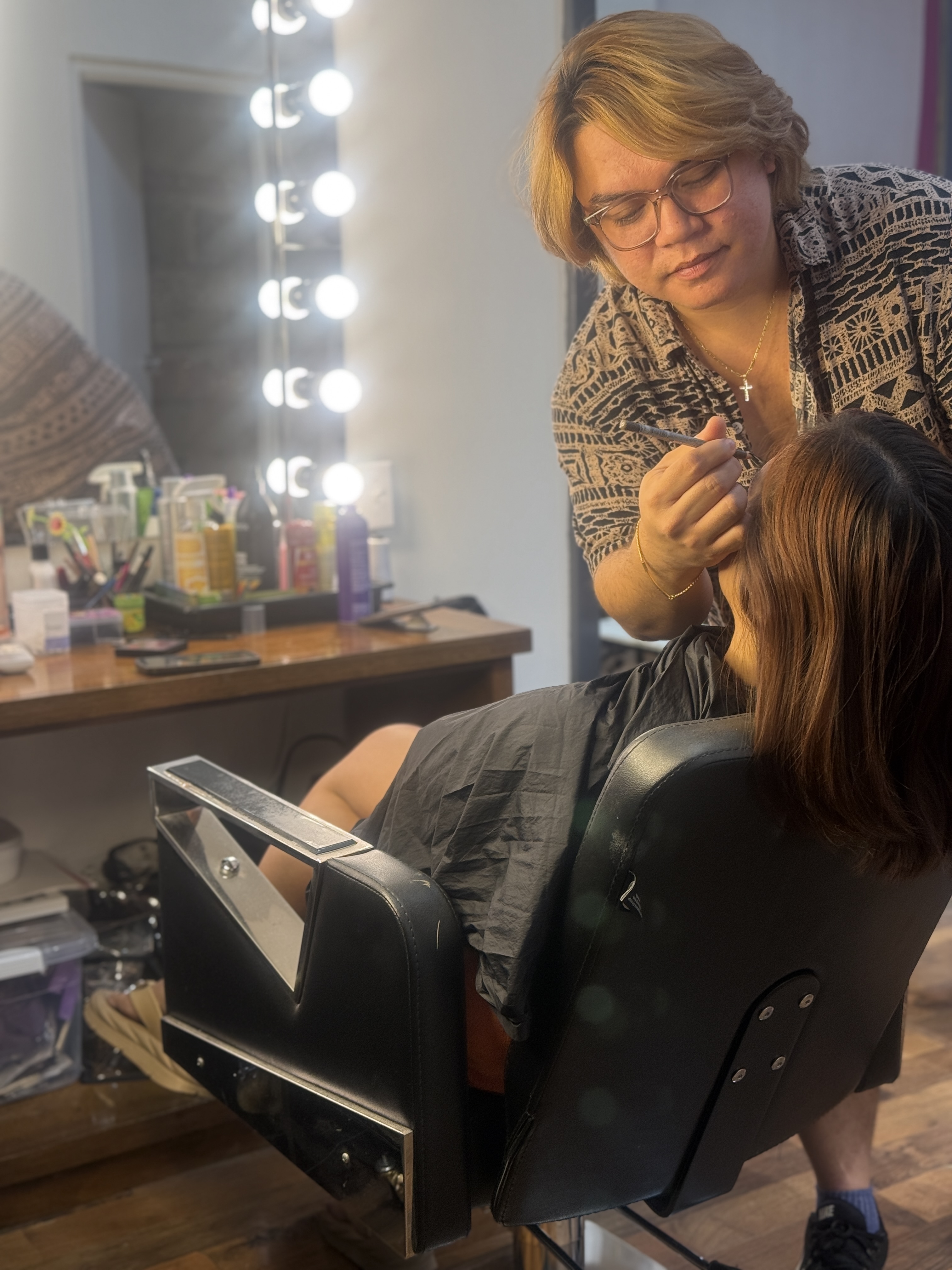 J.M. Gaduema, hair stylist and makeup artist at Natural Nail Spa, is shown in his natural element.