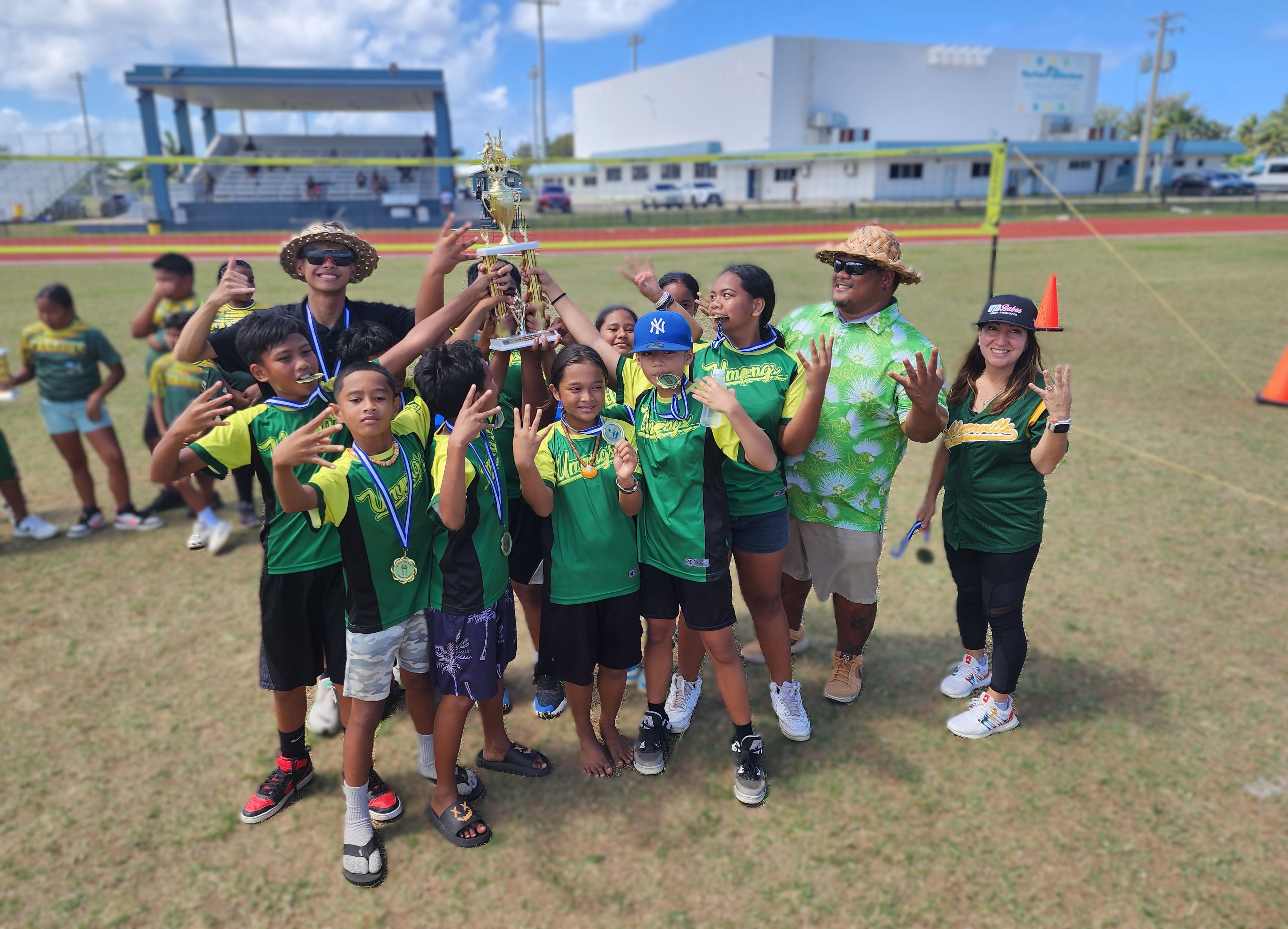 The Koblerville Elementary School 1 players pose with their championship trophy — their fourth — in the co-ed elementary division of the PSS-NMIVA Interscholastic Volleyball League SY24-25 at the Oleai Sports Complex on Saturday.