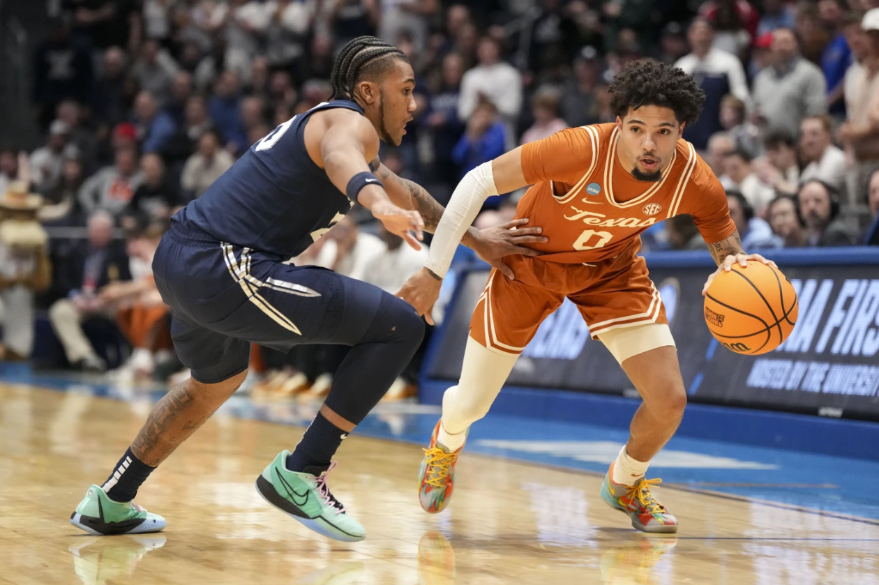 Texas guard Jordan Pope drives against Xavier guard Dayvion McKnight during the first half of a First Four college basketball game in the NCAA tournament, Wednesday, March 19, 2025.AP