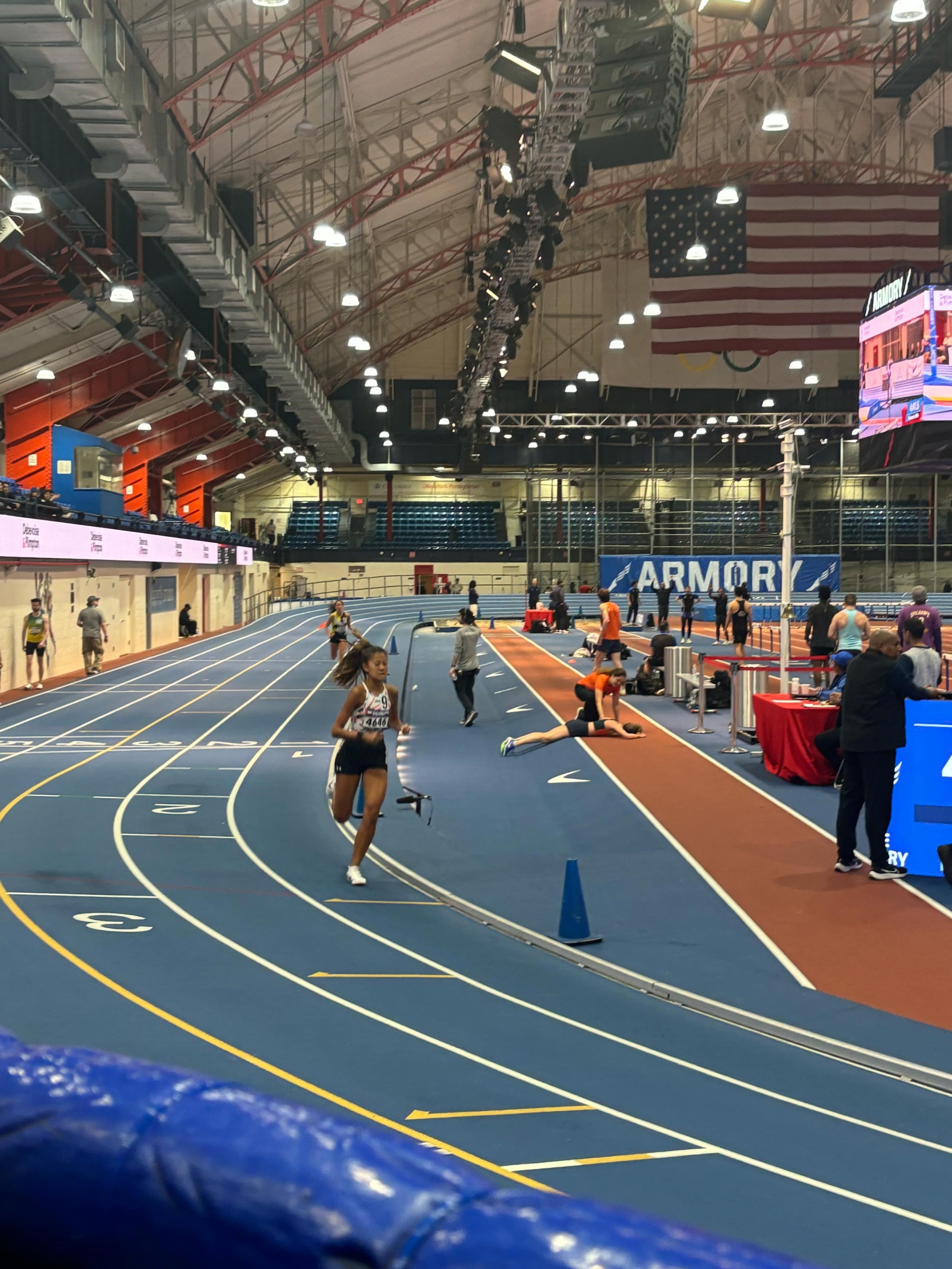 Tania Tan rounds a turn in the women’s 1-mile event at the NYRR Night at the Races 5 at the Armory Track in New York on Thursday.