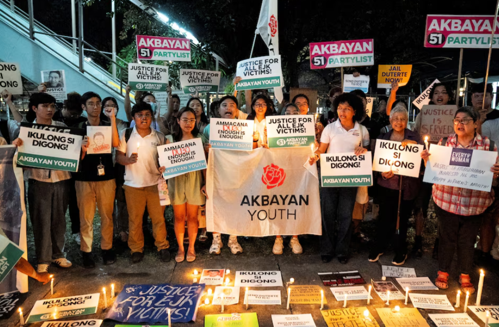 Activists hold placards and lit candles during a protest following the arrest of former Philippine President Rodrigo Duterte, in Quezon City, Metro Manila, March 11, 2025.REUTERS