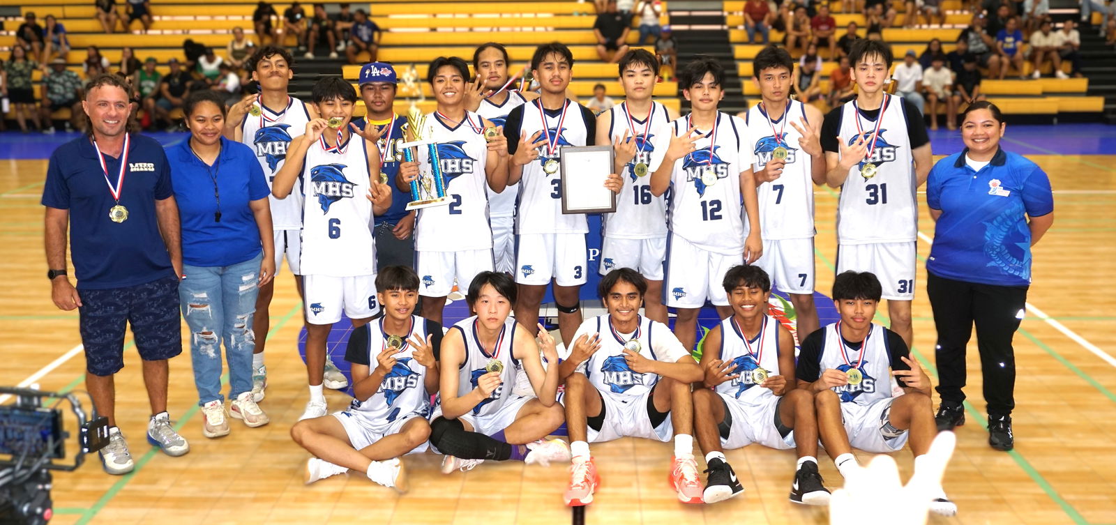 Marianas High School players pose with the boys high school division championship trophy and their medals during the awards ceremony of the PSS-NMIBF Interscholastic Basketball League SY24-25 at the Ada gym on Saturday.Photo by James F. Sablan Jr.