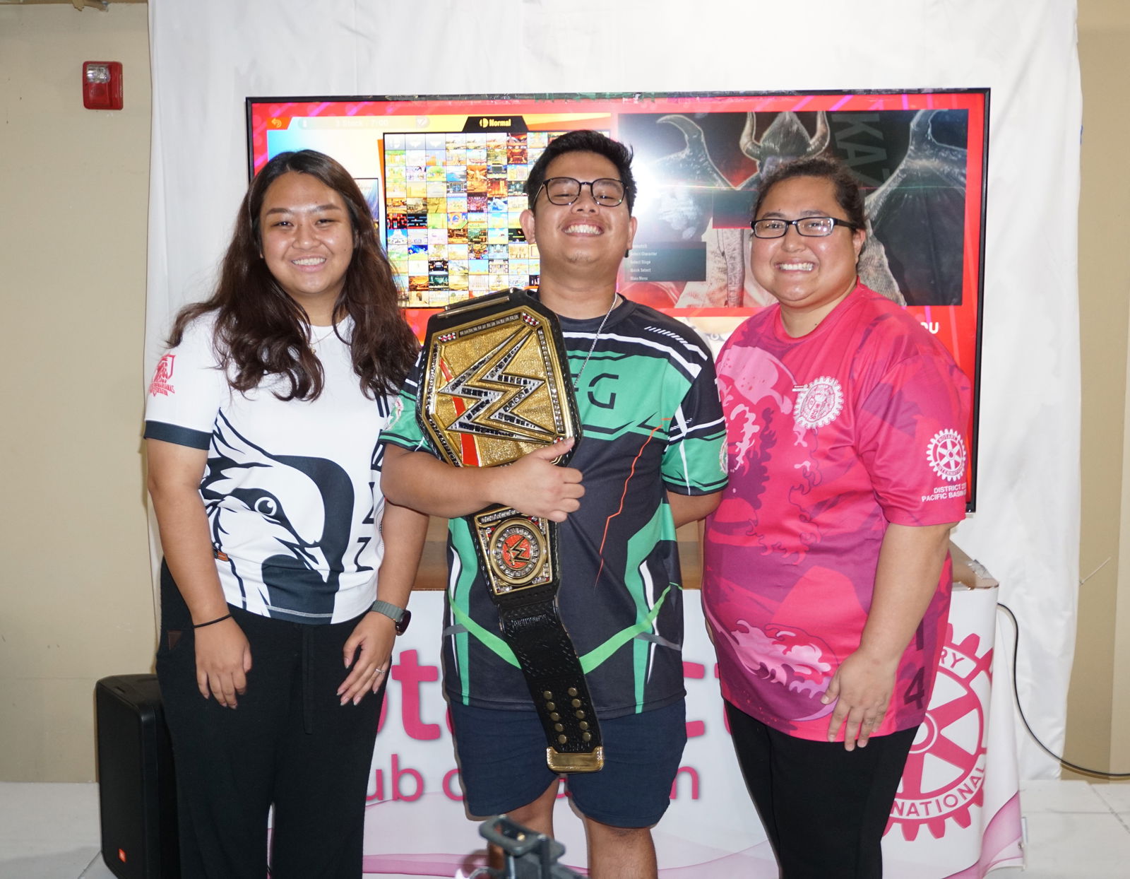 Patrick "KKURA" Pagdato poses as the Super Smash Bros Ultimate champion alongside Northern Marianas Esports Federation President Danielle “Dan” Acosta and Rotaract Club of Saipan President and Community Service Director Genelin Camacho during the awards ceremony of the Rotaract Rumble Gaming Tournament Vol. 1 at Marv’s Kitchen on the second floor of Saipan Vegas.Photo by James F. Sablan Jr.