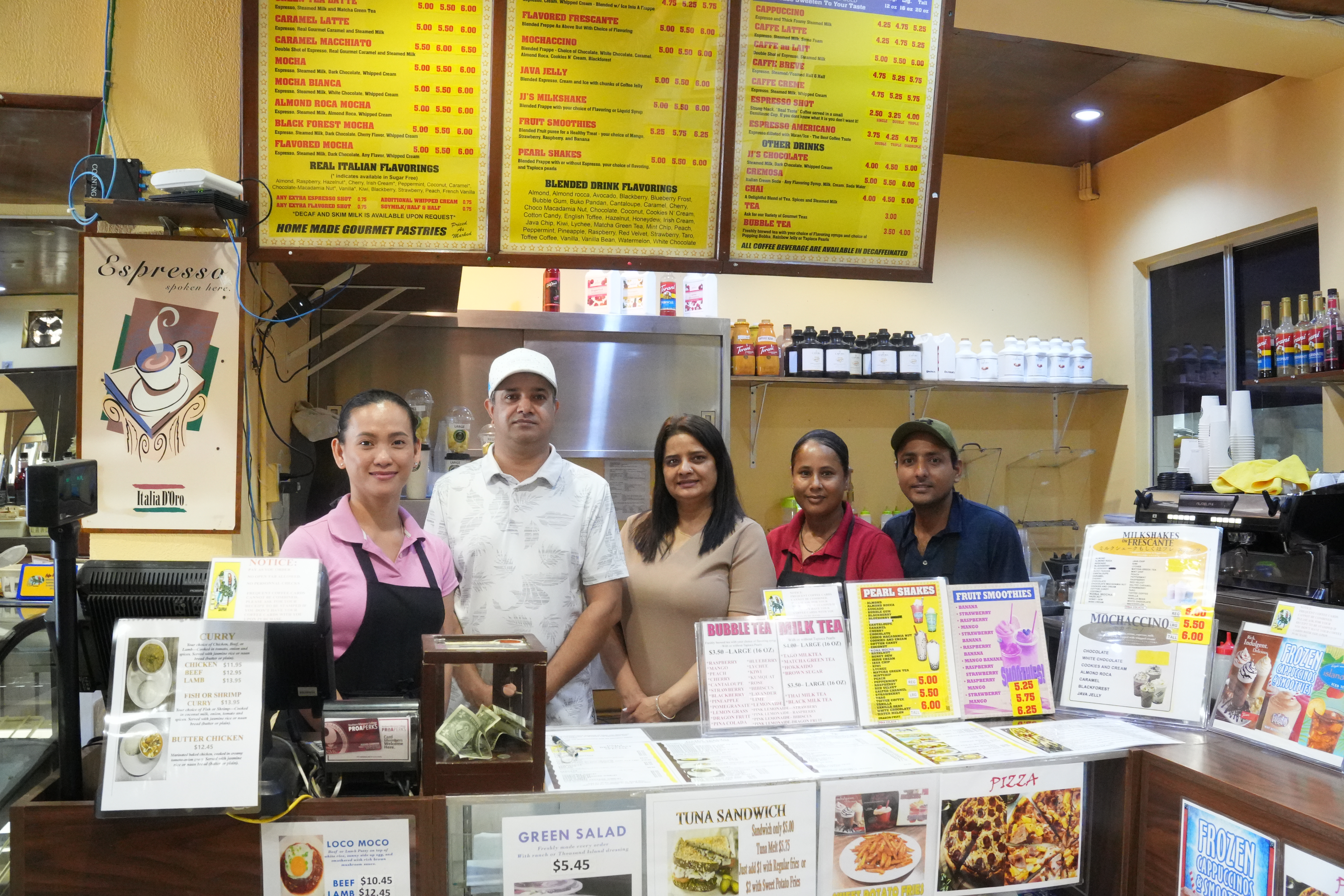 Java Joe’s manager Kathleen Tolentino, left, and cafe owner Manju Pandey, third from left, are joined by Java Joe’s staff for a photo.