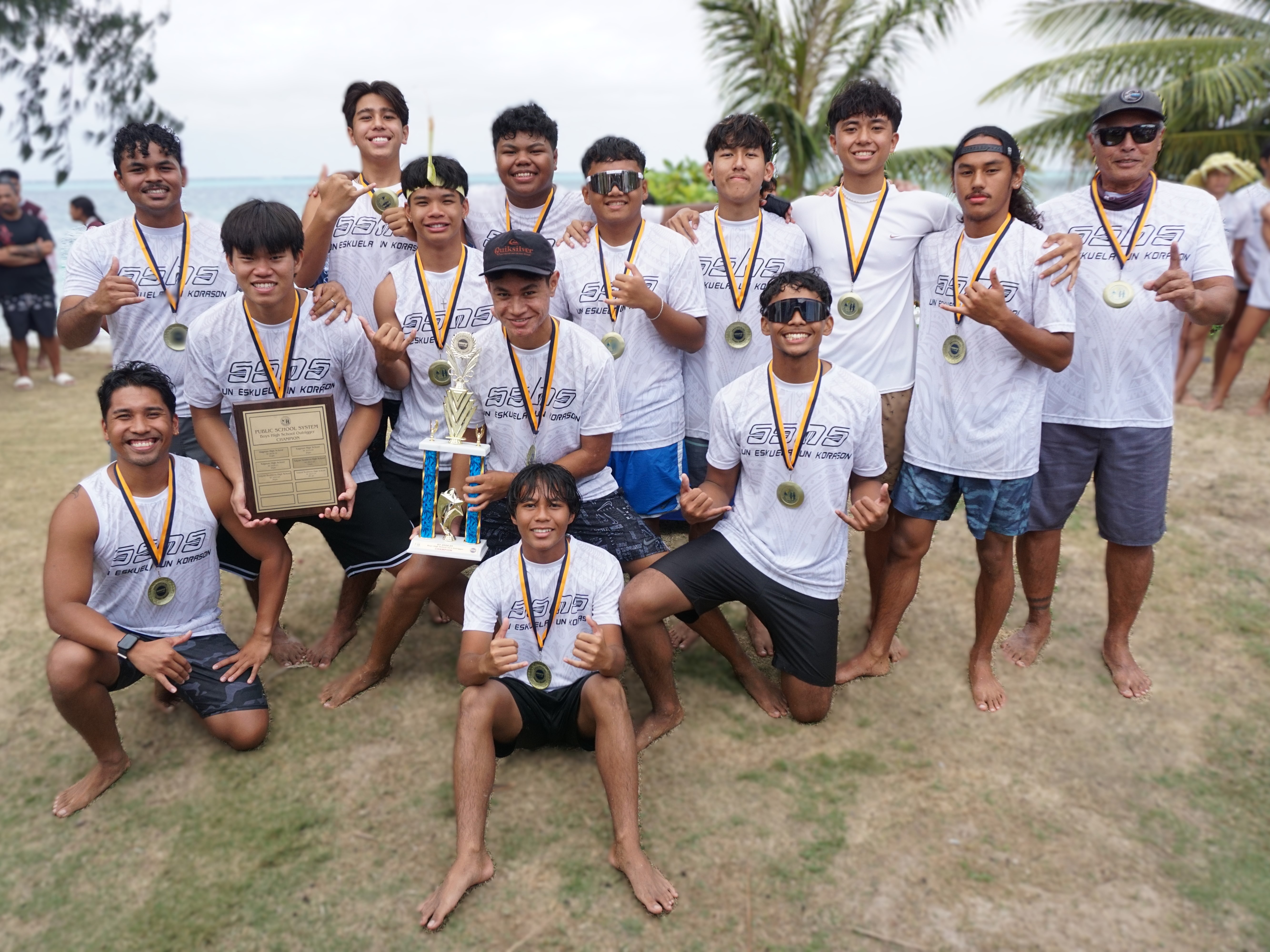 The Saipan Southern High School boys division team members pose for a photo with the first-place trophy of the PSS-NMNPSF Interscholastic Outrigger Race Series SY24-25 during the awards ceremony at Kilili Beach on Saturday.