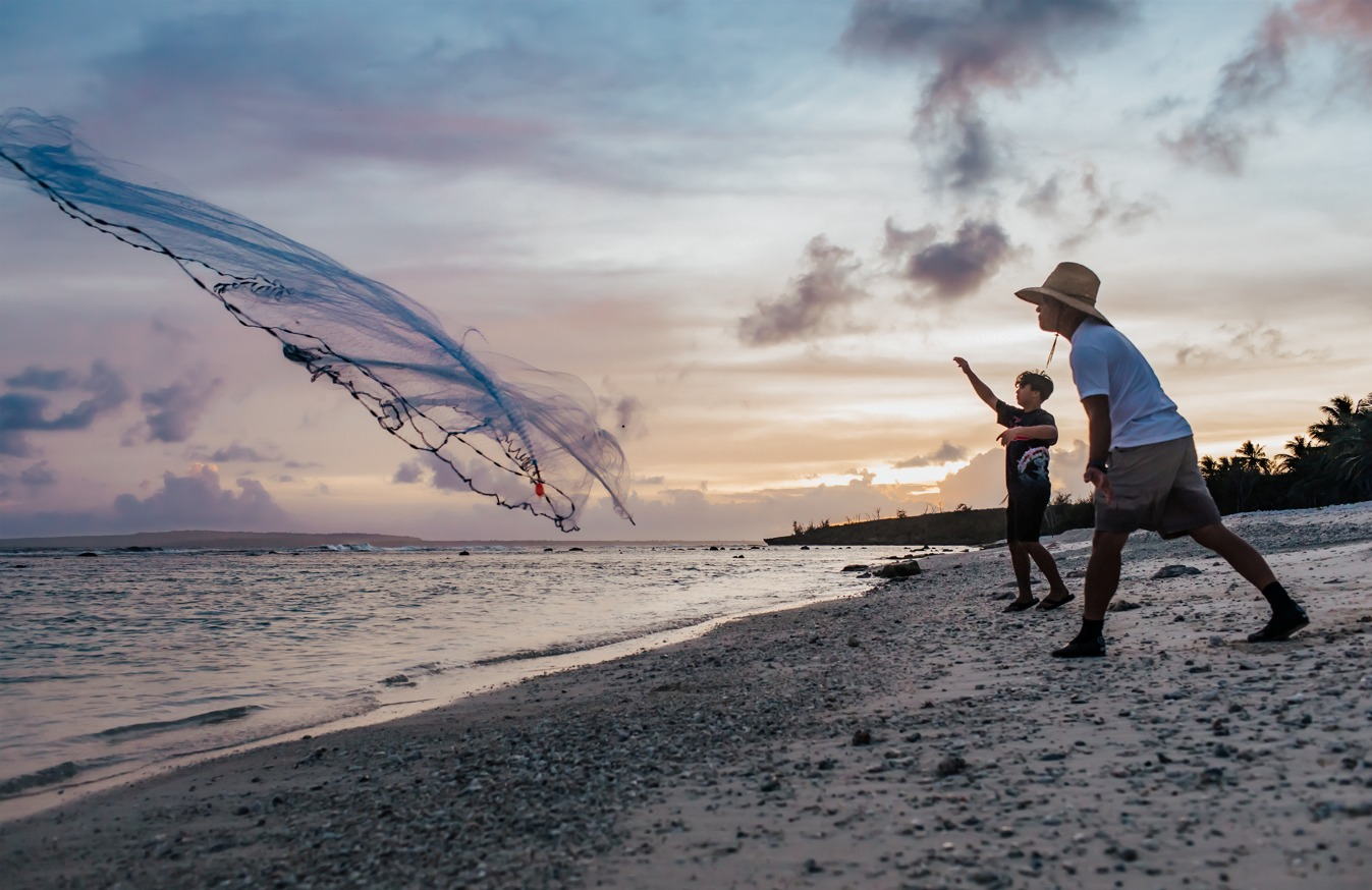 Talaya Club instructor Jesse Chong, foreground, and his nephew Zion cast talayas into the water.
