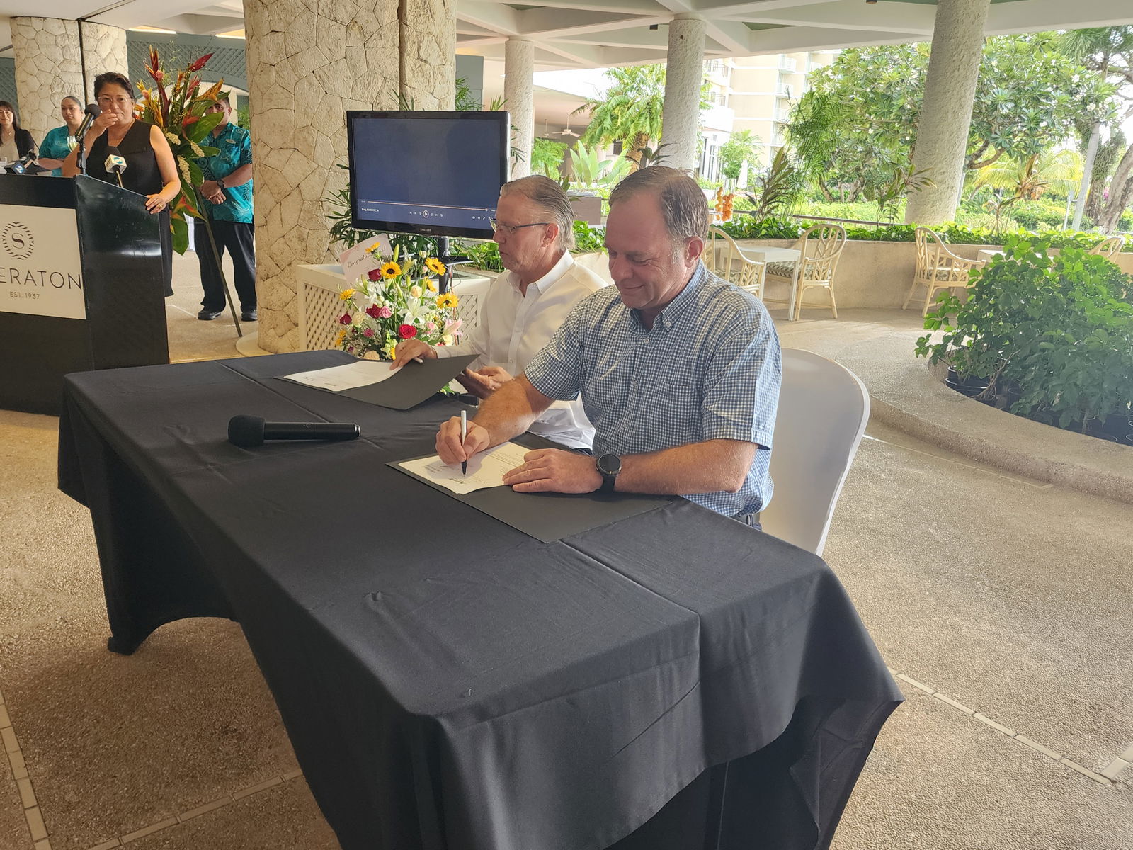MB Capital LLC President David Hood and Asia Pacific Development, Marriot International Regional Vice President Peter Gassner sign the Sheraton franchise agreement on Friday while MB Capital general manager Gloria Cavanagh looks on.