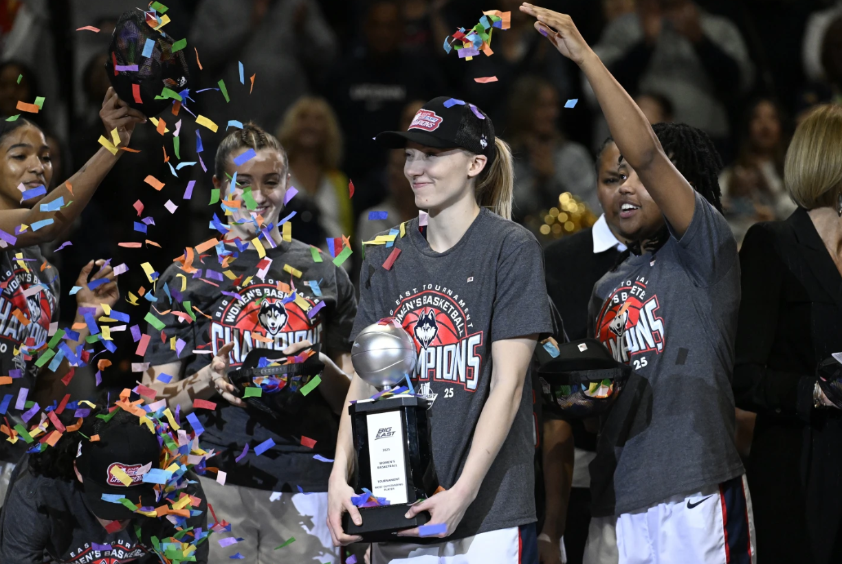 UConn’s Paige Bueckers, center, holds the Most Outstanding Player trophy after they defeated Creighton in an NCAA basketball finals game of the Big East Conference tournament, Monday, March 10, 2025 in Uncasville, Conn.