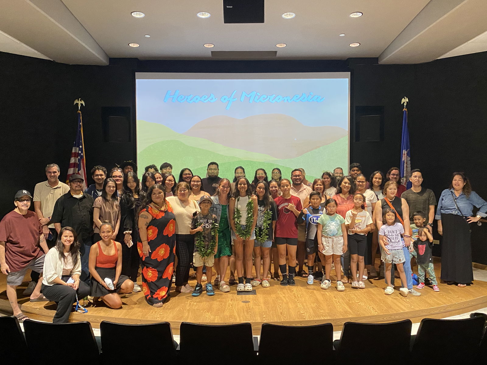 Audience members pose for a group photo with Nihi Indigenous Media at American Memorial Park’s indoor theater.