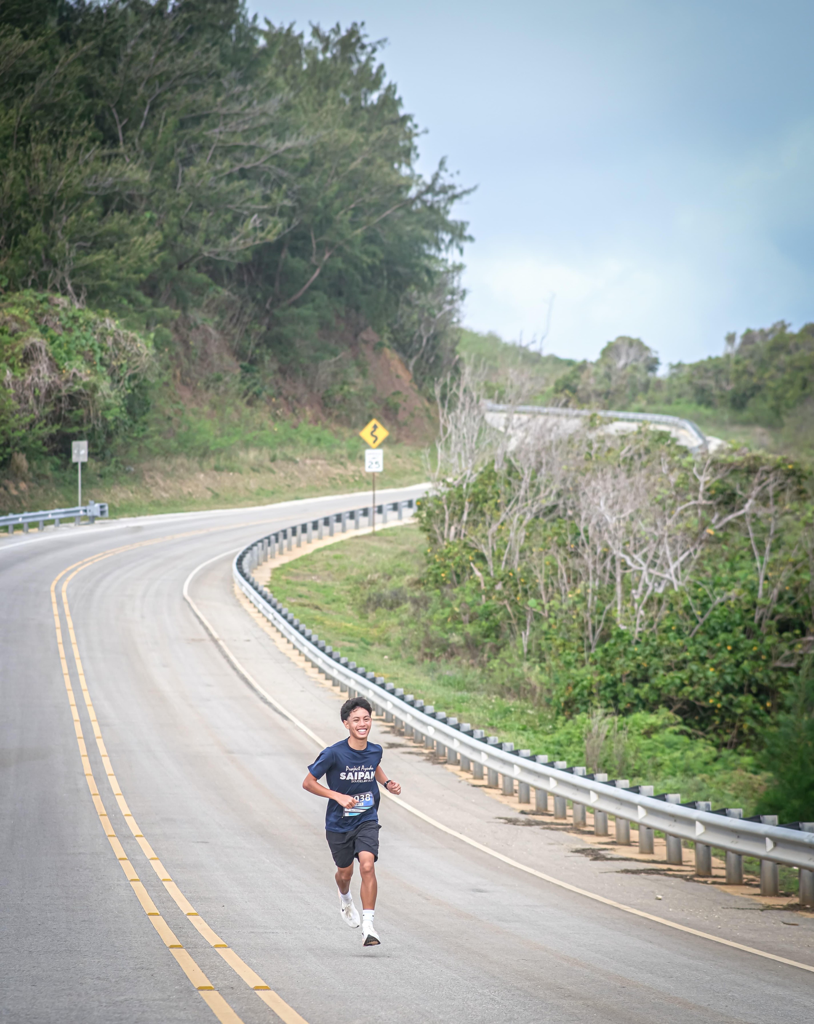 Nash Santos smiles as he reaches the final leg of Run Saipan's Mangrove 5K Saturday morning on Route 36.