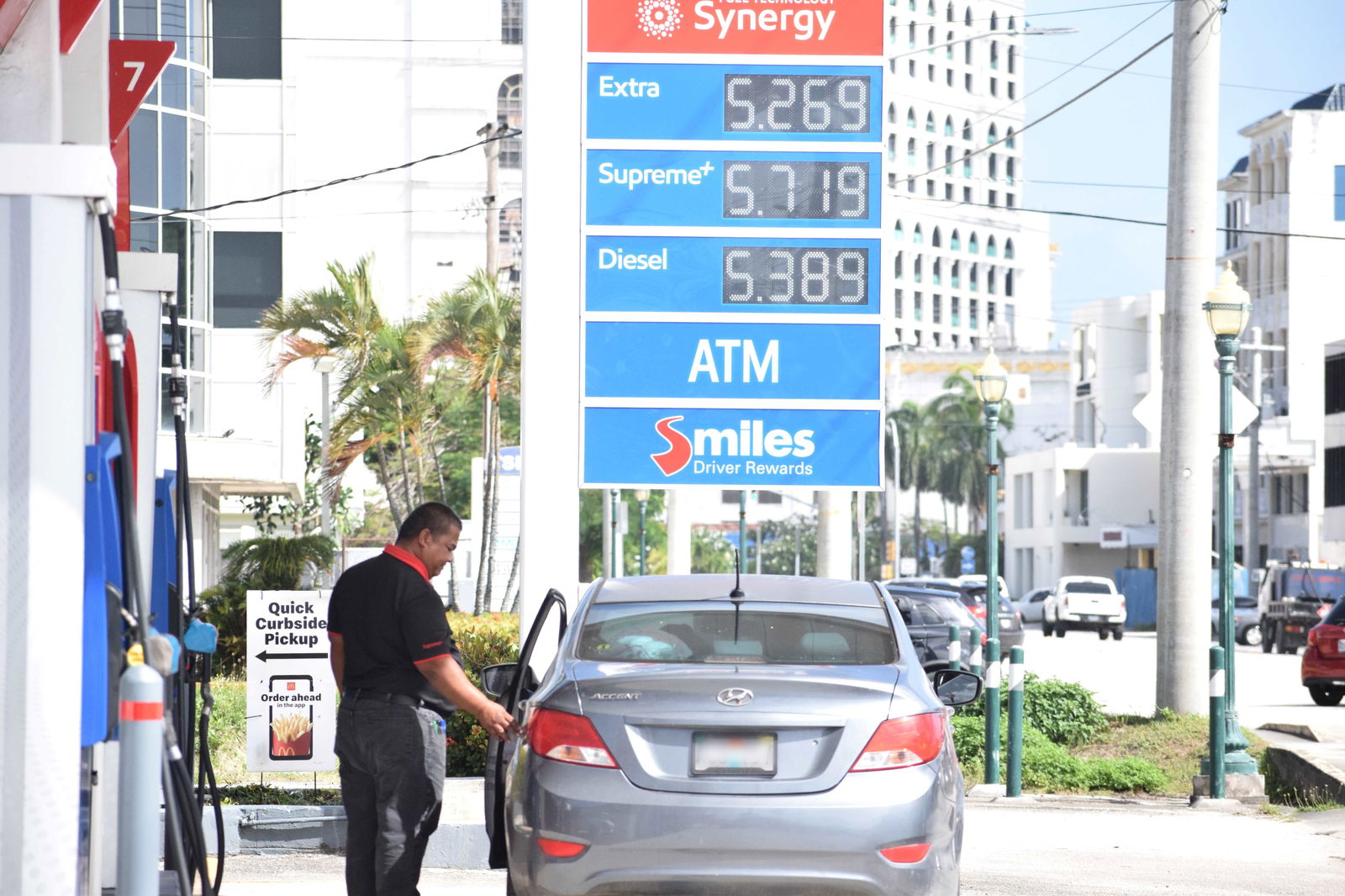 A gas attendant at Mobil Oil Beach Road in Garapan serves a customer on Monday.