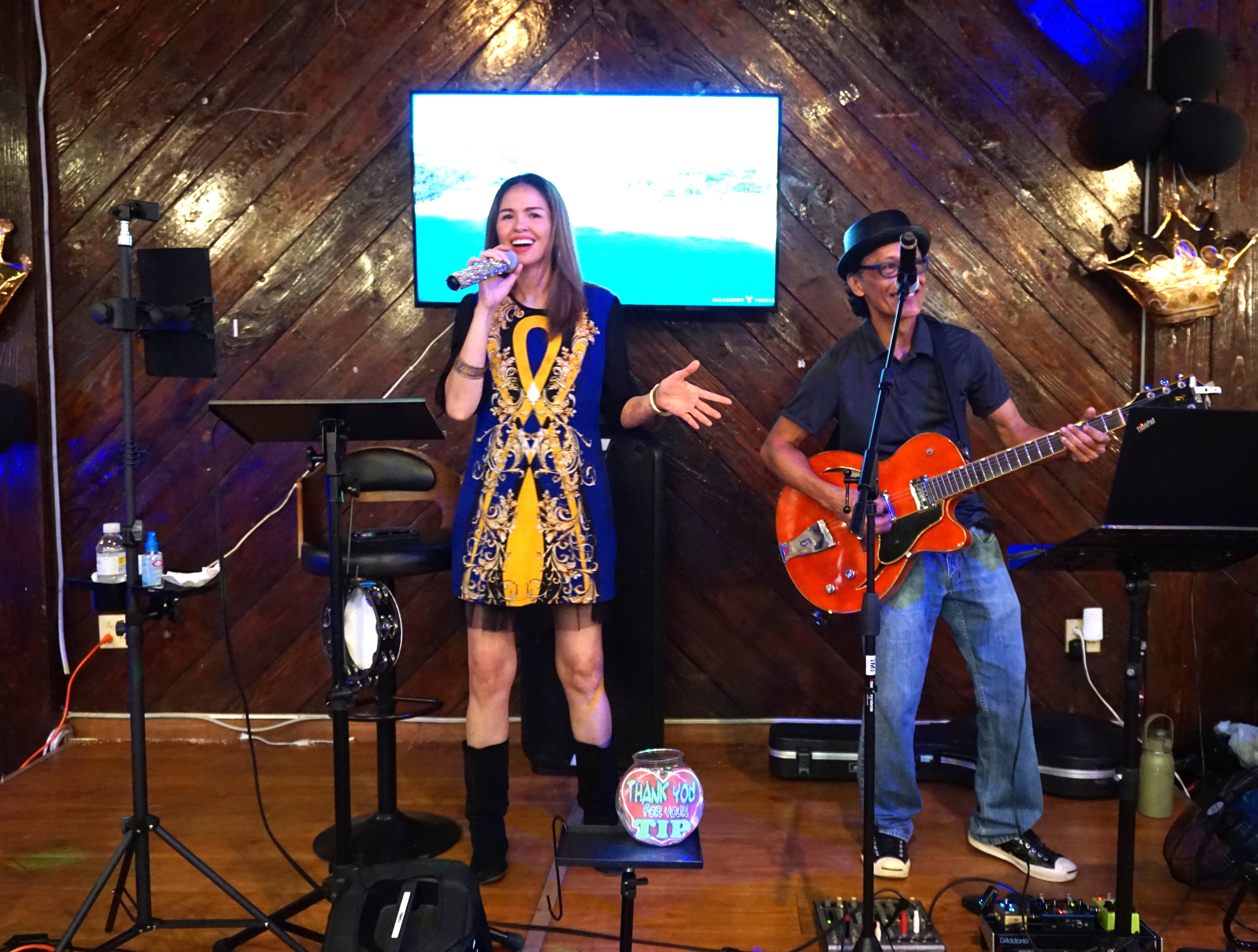 Joy Yumul, left, and Ruel Contreras perform from Thursdays to Saturdays at 360 Beach Club, where the drinks are cold, the food is good, and the sunsets are free. 