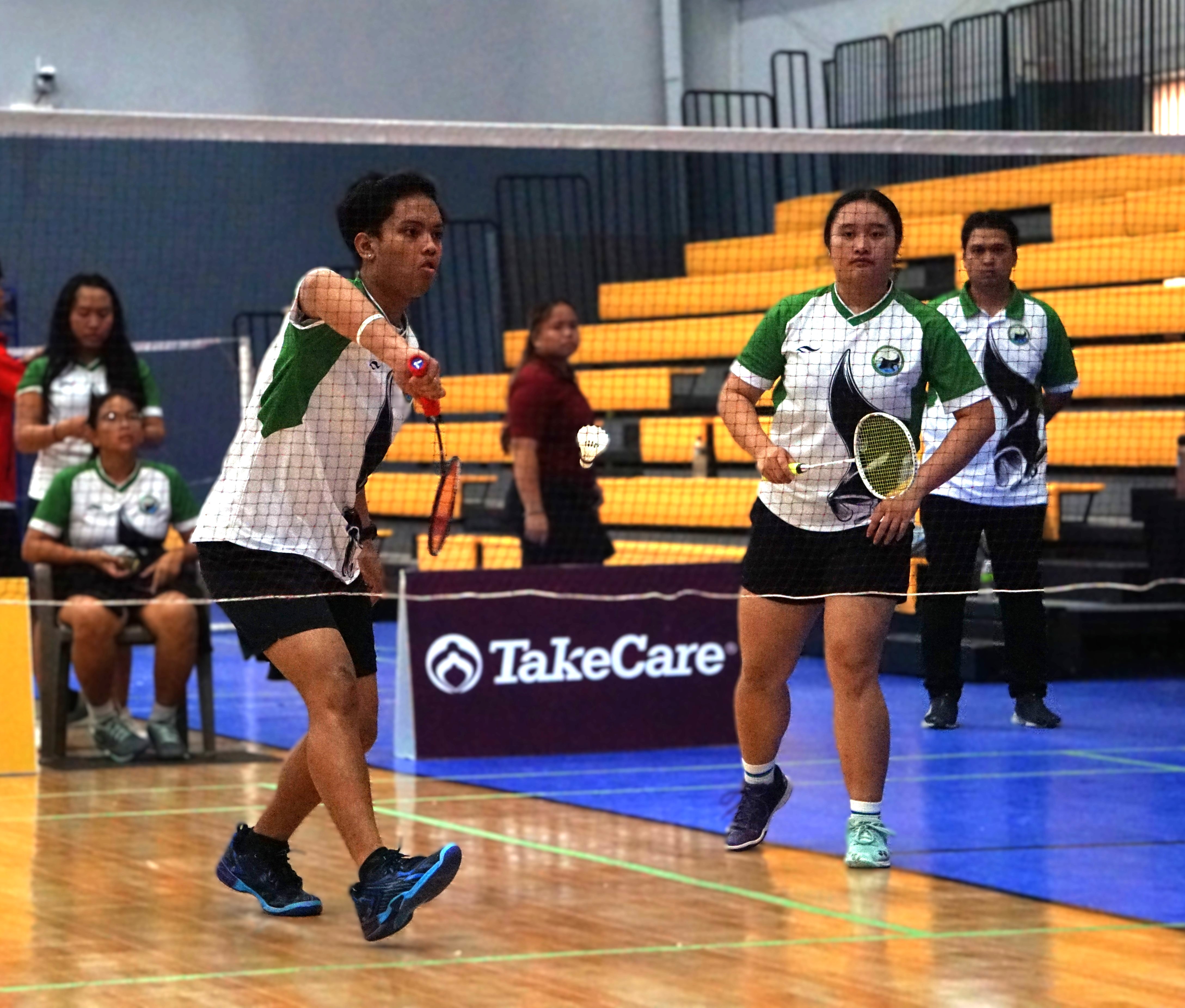 SSHS 1’s Jude Mallari extends for the backhand return while teammate Shaina Malonzo looks on during a mixed doubles match in the playoffs round of the PSS-NMBA Interscholastic Badminton League high school division at the Ada gym on Saturday.