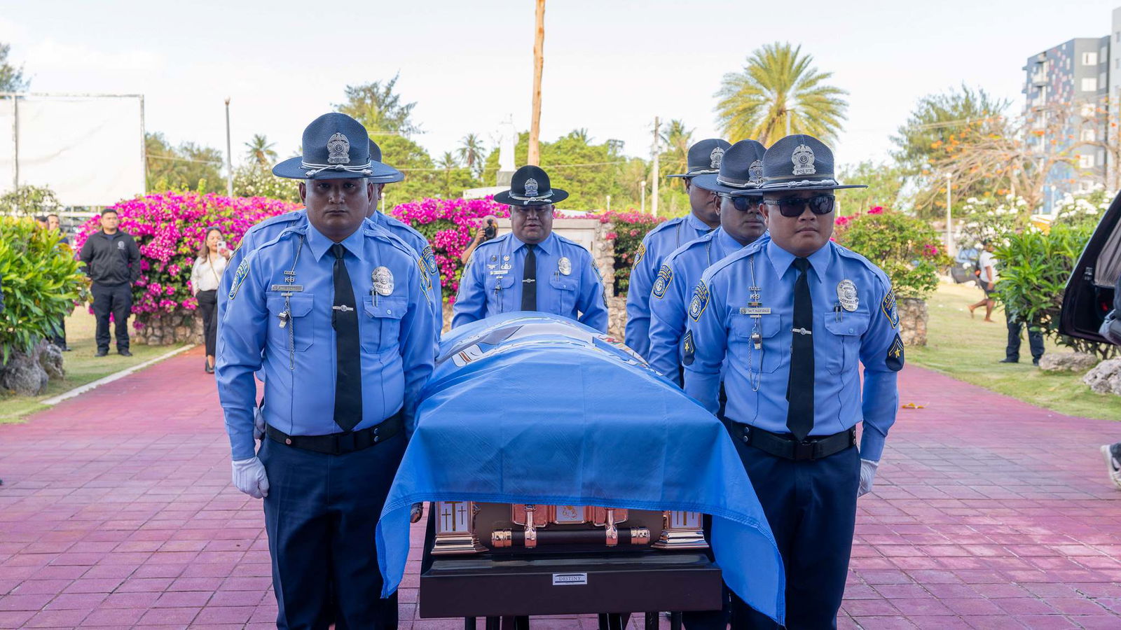 Department of Public Safety officers stand guard near the casket of former Speaker Oscar M. Babauta at the entrance of Mount Carmel Cathedral on Tuesday.Contributed photo