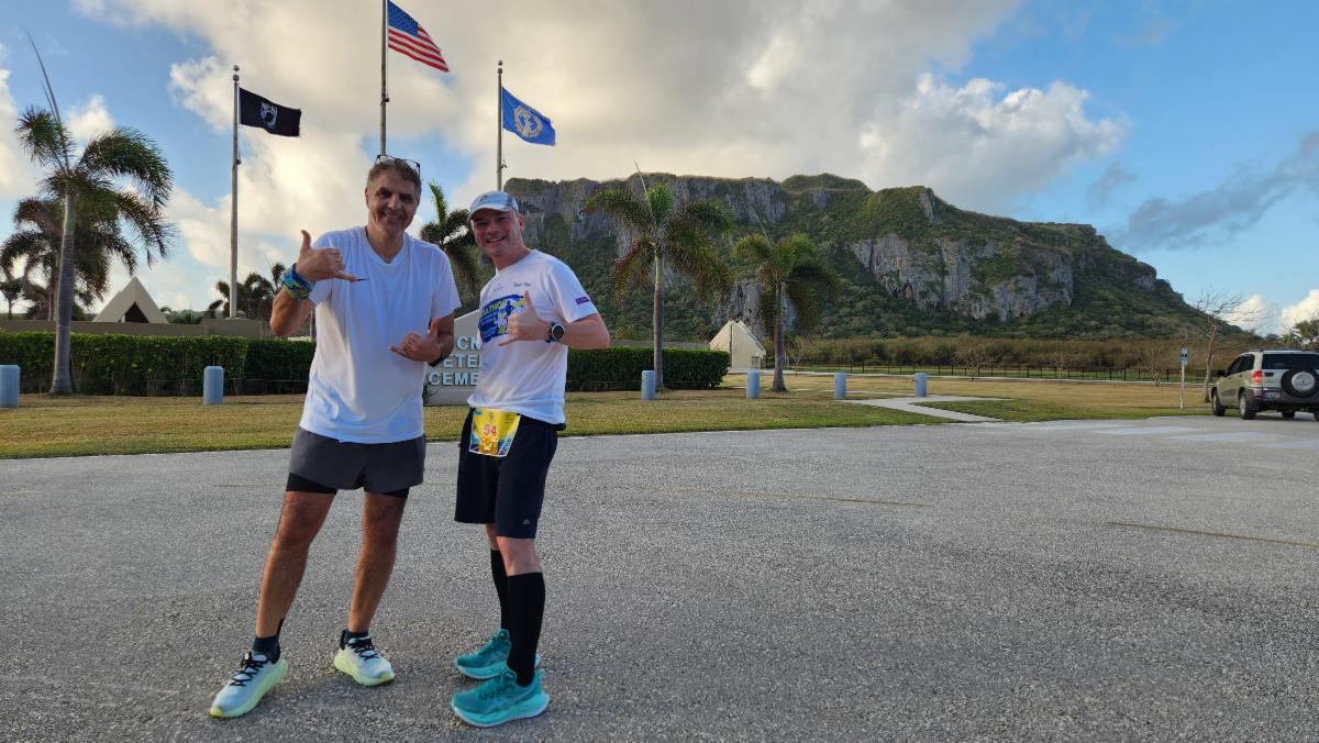 Wojciech Machnik of the U.S., right, and a fellow marathoner pause for a commemorative photo during Skechers Saipan Marathon 2025 on March 8, 2025. The pair are part of a larger group of runners from Europe who run marathons around the world.