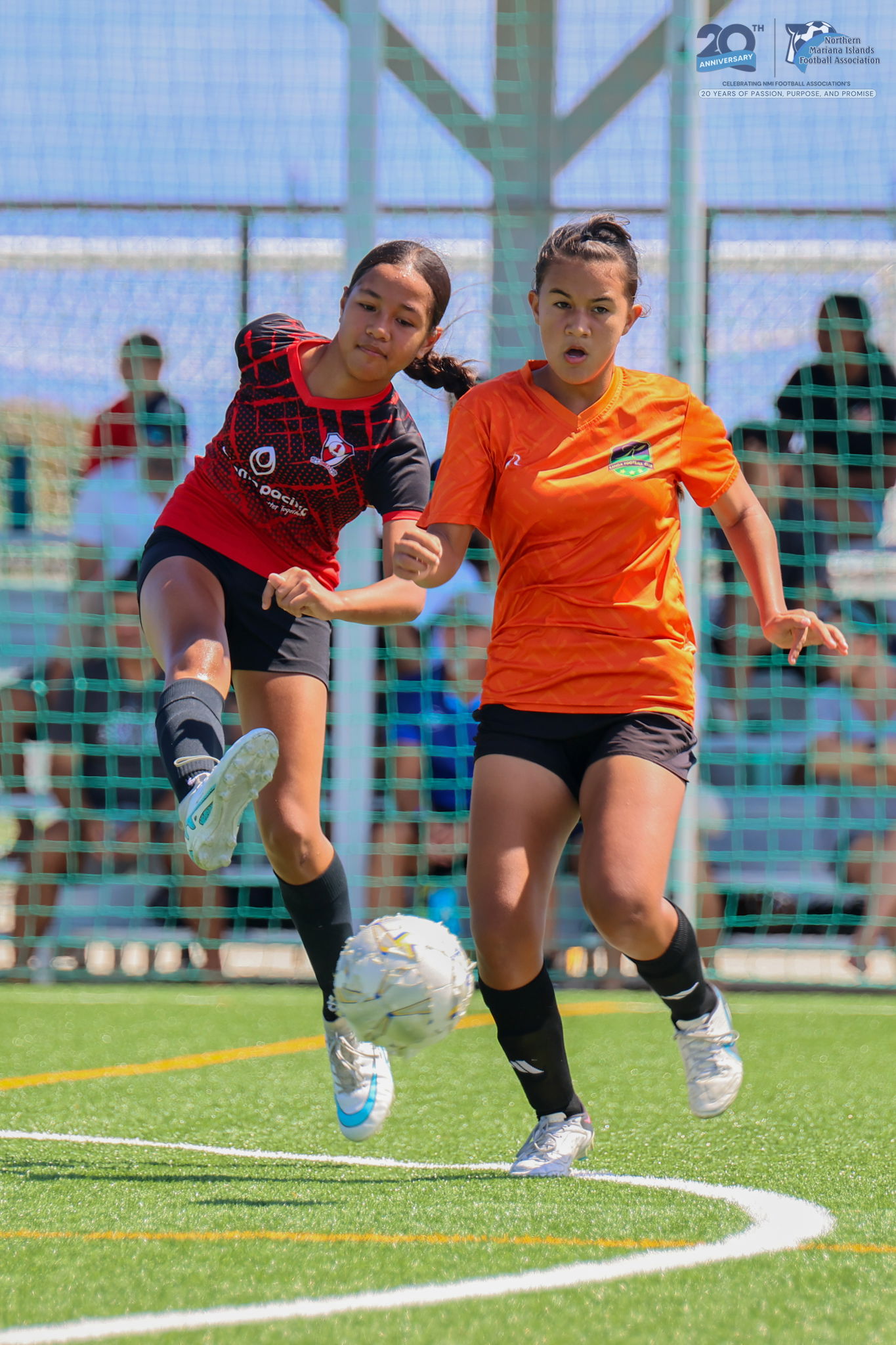 Kanoa Football Club's Windsor Gross battles with a Paire Football Club player for the possession during a U17 girls division game of the TakeCare Youth Soccer League Spring 2025 at the NMI Soccer Training Center in Koblerville. NMIFA photo