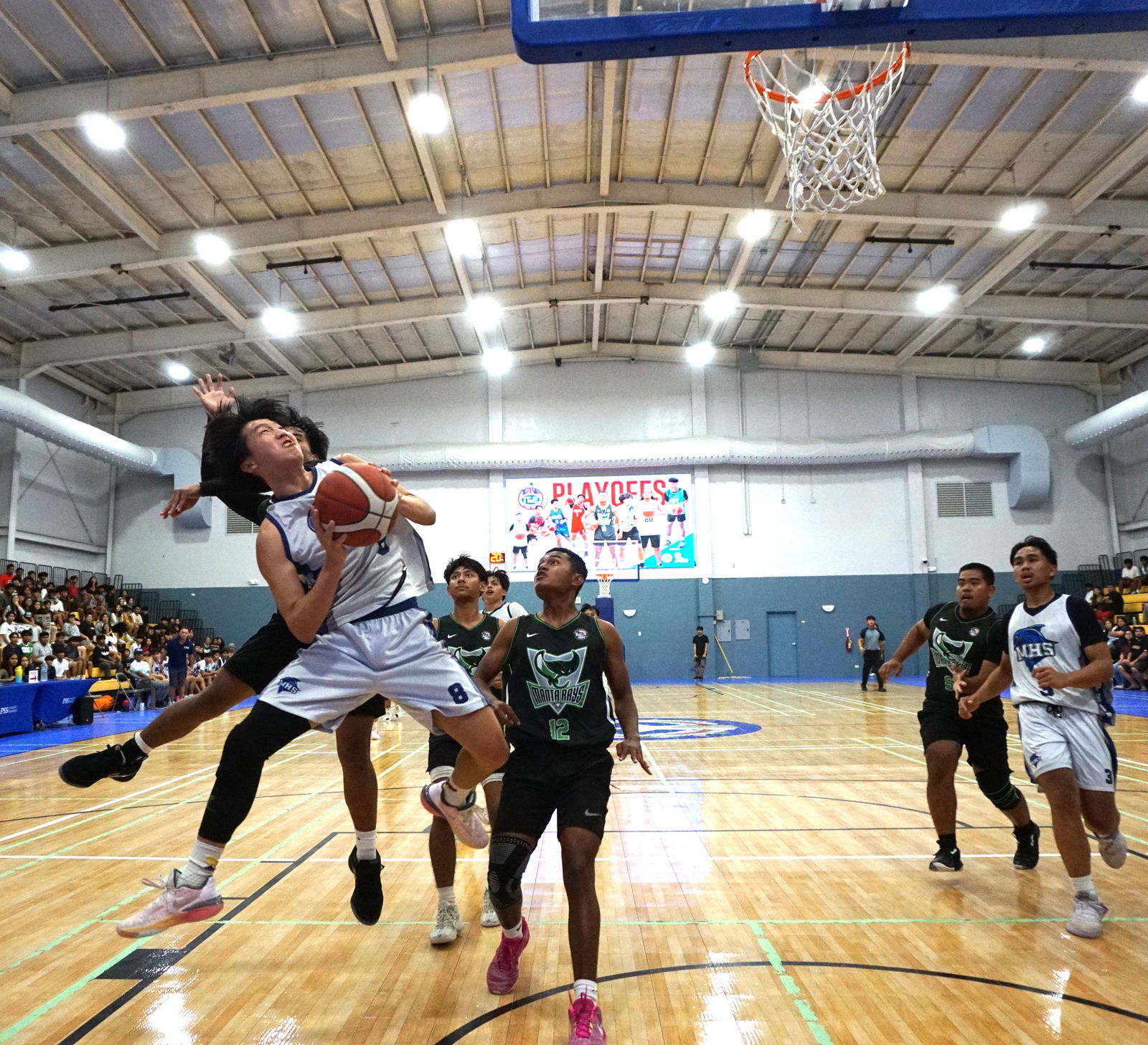 MHS’ Elijah Ye takes an off-balanced shot as he gets fouled during the title game against SSHS in the boys high school division of the PSS-NMIBF Interscholastic Basketball League SY24-25 at the Ada gym on Saturday.Photo by James F. Sablan Jr.