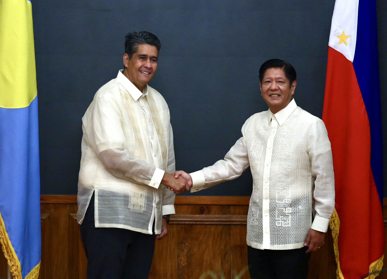 Philippine President Ferdinand Marcos Jr., right, and Palau President Surangel Whipps Jr. shake hands during a bilateral meeting in the state dining room of the Malacañang presidential palace in Manila on Monday, Feb. 24, 2025. Pool photo by Mark Balmores