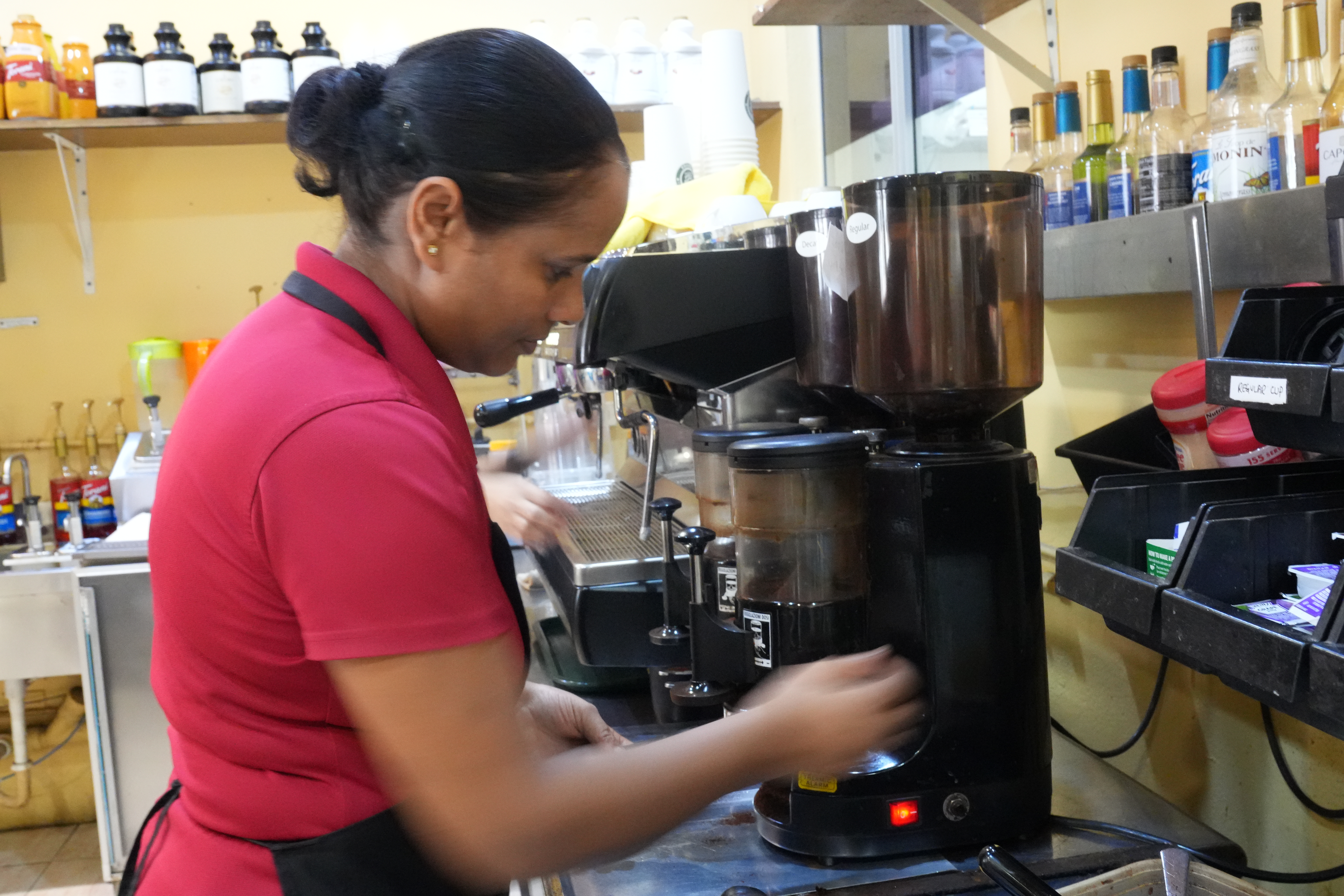 A Java Joe’s staff prepares the coffee machine.