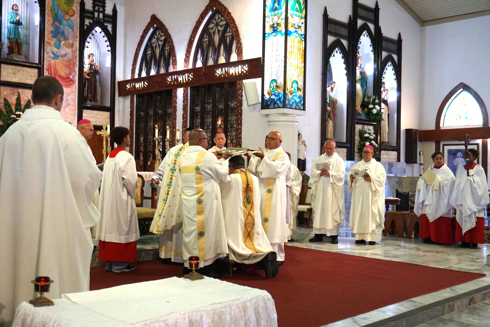 The Gospel is held above Bishop Romeo Convocar as part of his ordination.