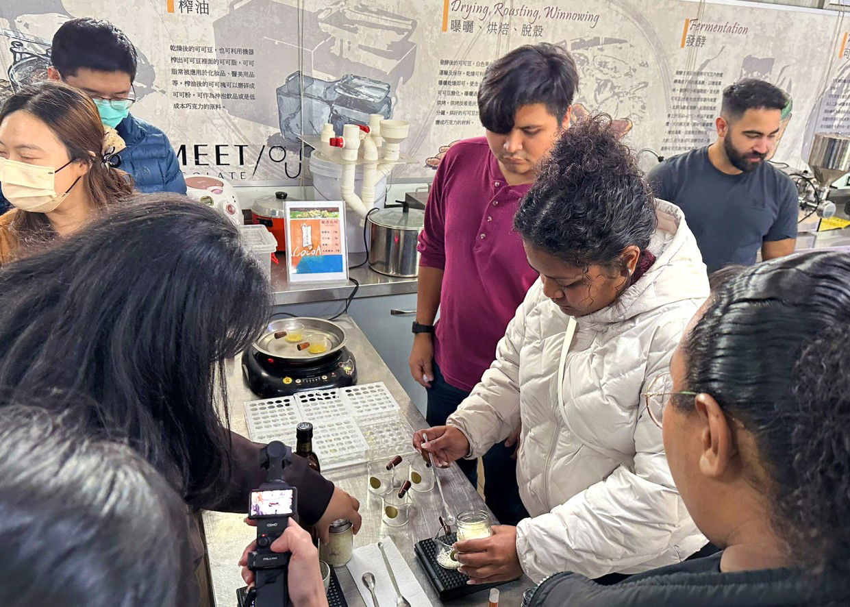 UOG business major Keana Mesubed, right, and agriculture major Kaelan Arciaga concoct a cocoa-based lip balm during a tour of the Smart Agriculture Center at the National Pingtung University of Science & Technology campus.