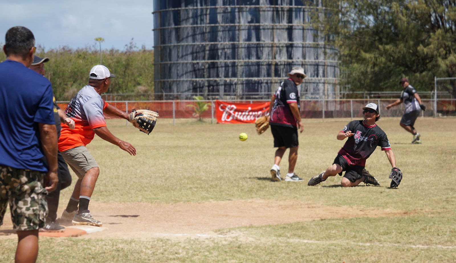 Eagle Rays’ Mike Tomokane tosses the ball to first base in a pickoff attempt during a game against Ngatpang in the open division of the 2025 Budweiser Belau Amateur Softball League at the Dandan softball field on Sunday.