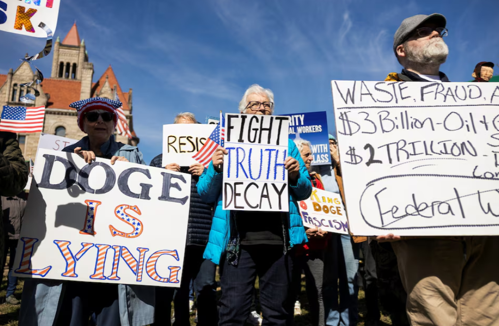 Protesters are seen at a rally standing up for federal workers in downtown Parkersburg, West Virginia, Feb. 28, 2025.