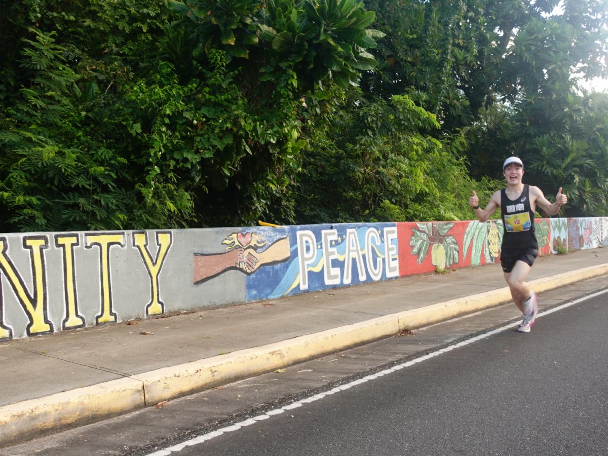 Kaneko Yuya of Japan passes street art in the village of San Roque during Skechers Saipan Marathon 2025 on March 8, 2025.