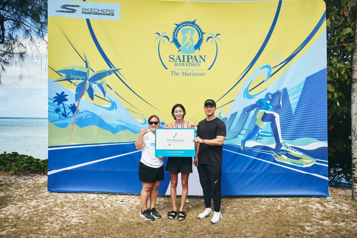 Honorary Marianas Tourism Ambassador for sports and South Korea actress UIE, center, celebrates her full marathon finish at Skechers Saipan Marathon 2025 on March 8, 2025. From left, Marianas Visitors Authority Deputy Managing Director Judy C. Torres, UIE, and MVA Marketing Manager Thomas Kim.
