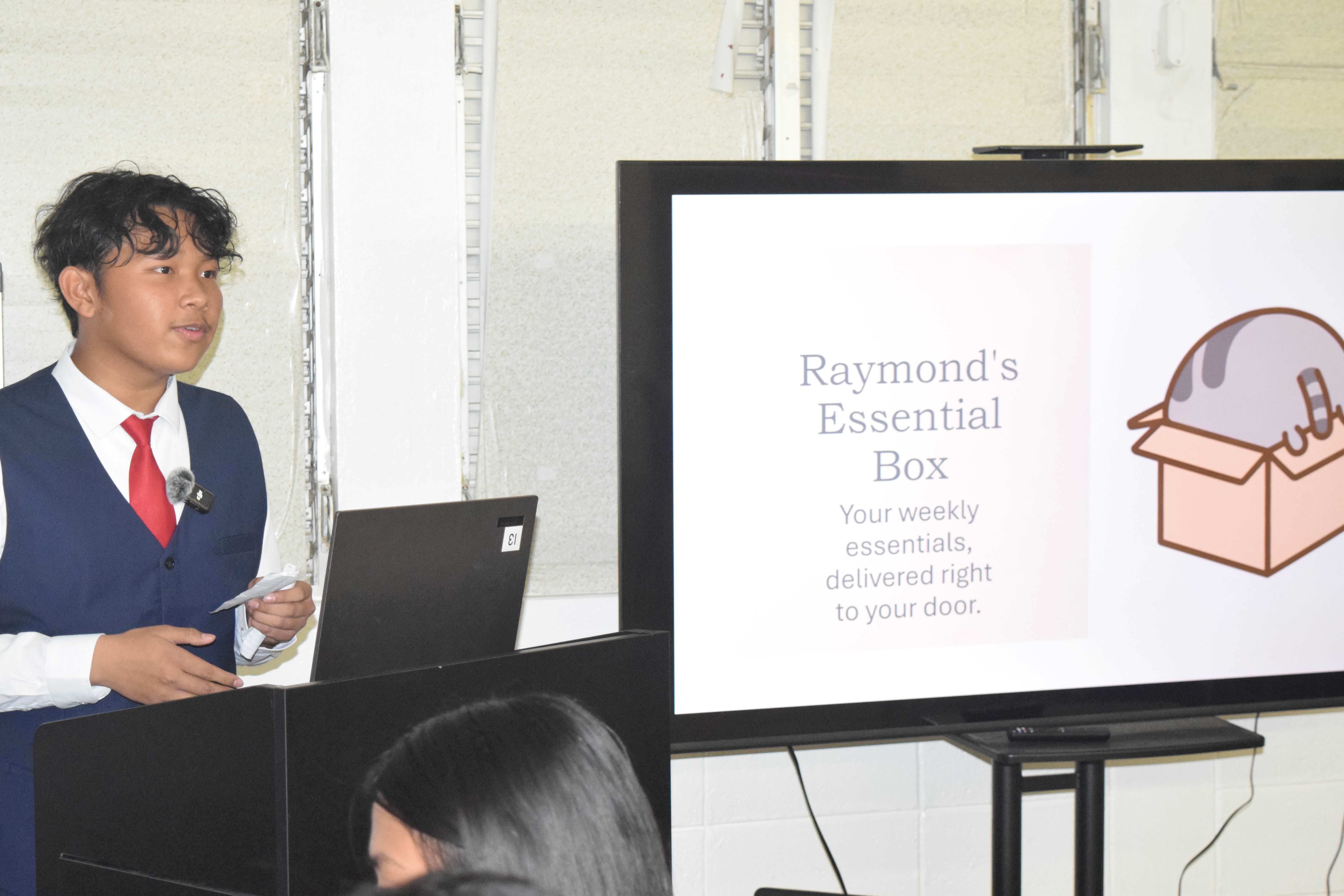 Marianas High School ninth grader Raymond King Jr. pitches his business idea to the Shark Tank panel.