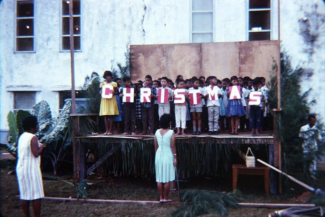 Built in 1958, Oleai Elementary School on Saipan, was one of the schools that Peace Corps volunteers served. In this photo, elementary students perform during a Christmas Concert. This was a photo taken between 1967 to 1971 from the Facebook page Mariana Memories-Micro. 