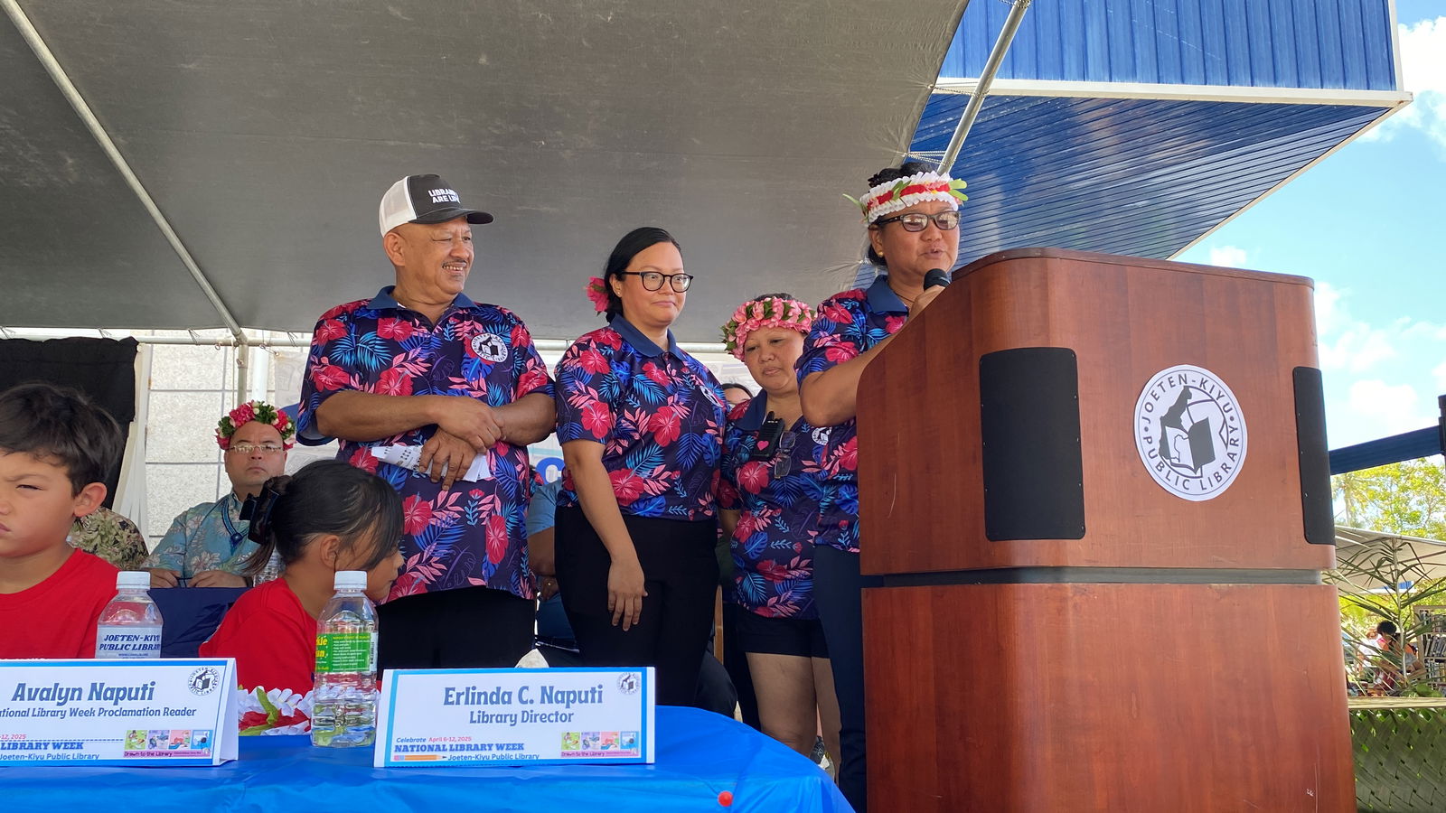 Joeten-Kiyu Public Library Director Erlinda Naputi,  at the podium, delivers her remarks during the Literacy Block Party on Saturday, April 5, 2025.