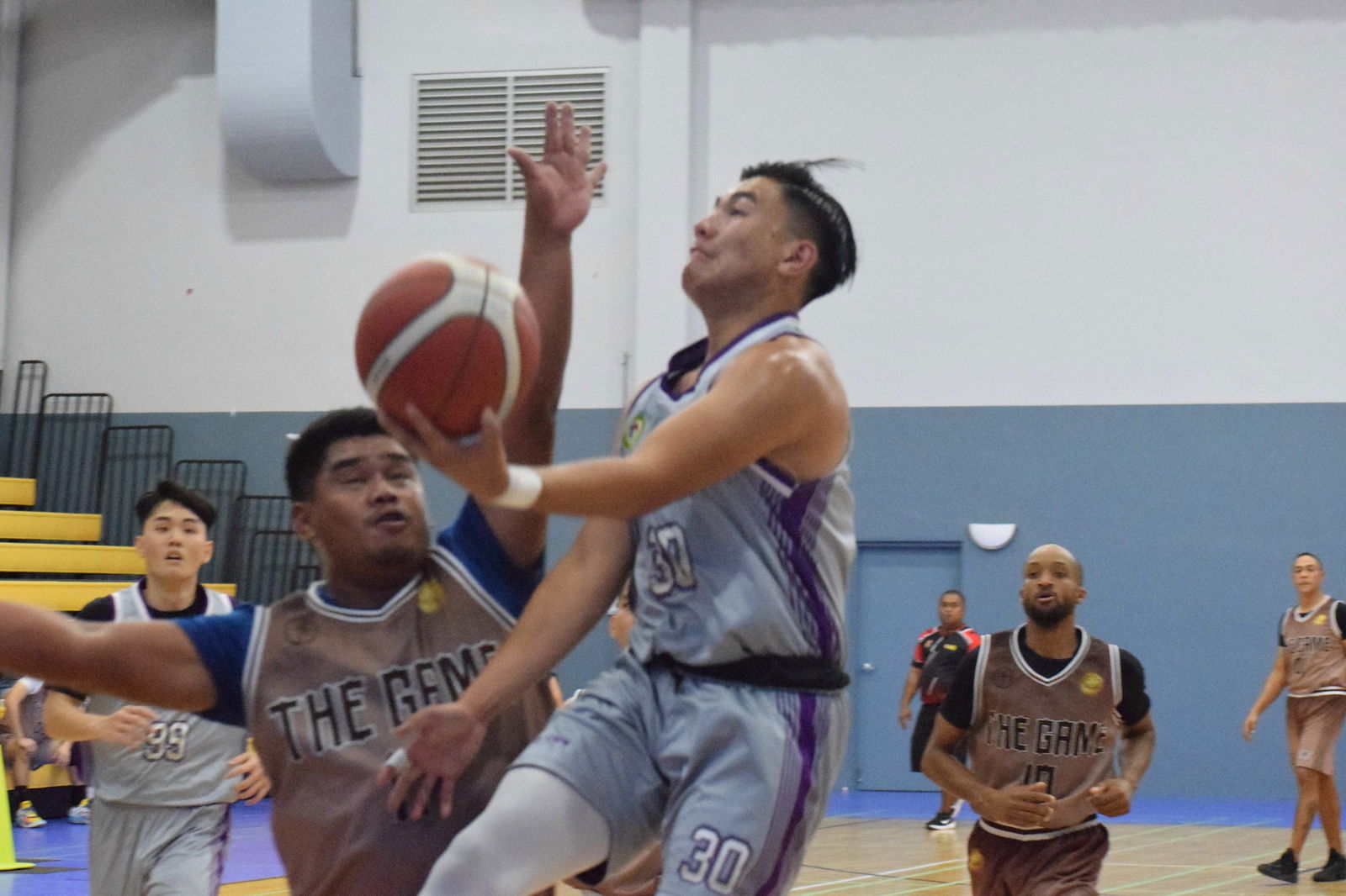 Priority Care’s Steve King goes for a layup against The Game’s John Libut during an IT&E United Filipino Organization Basketball League game at the Ada Gym on Saturday.Photo by Emmanuel T. Erediano