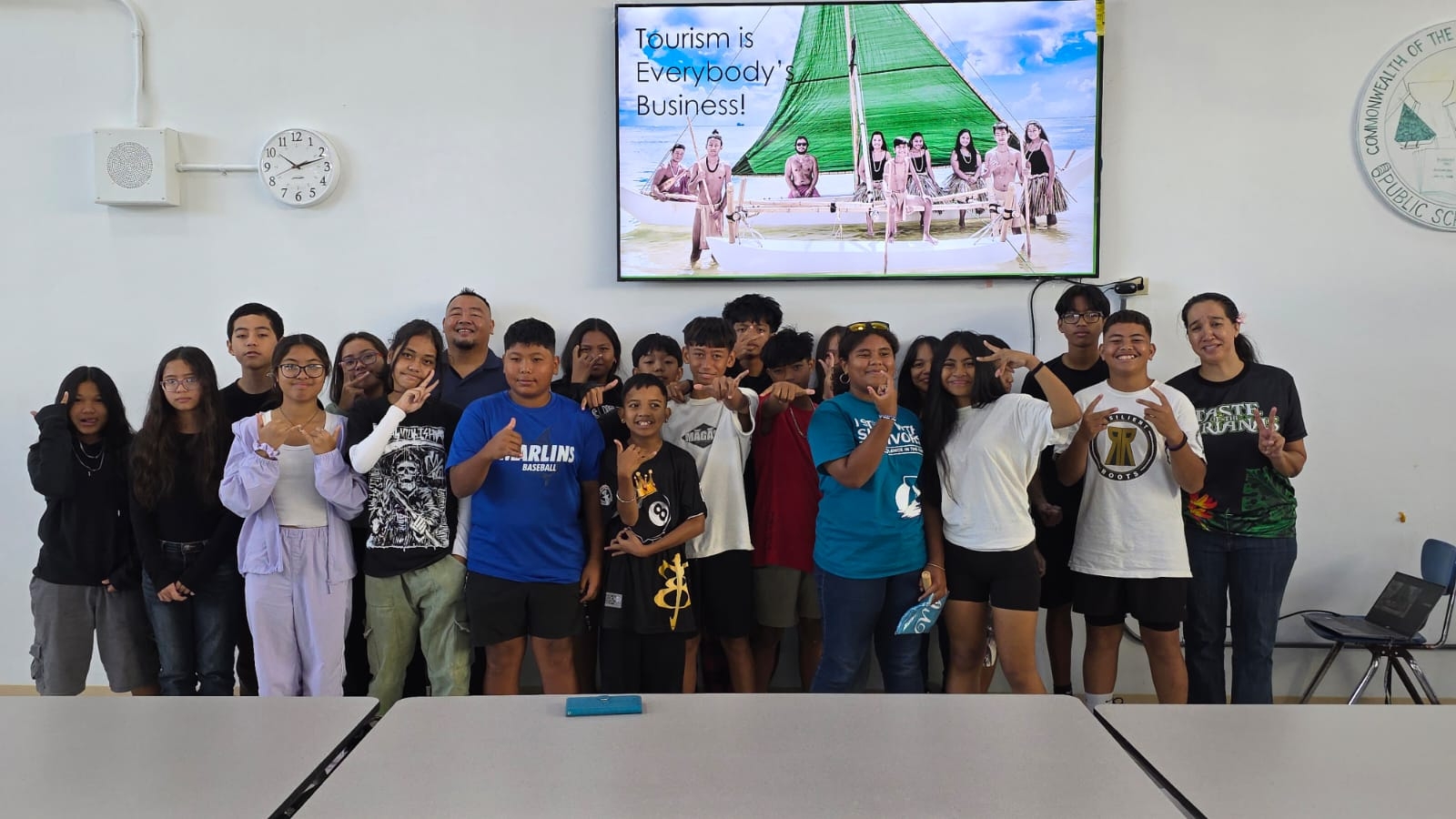 One of the 7th grade classes of Chacha Ocean View Middle School take a commemorative photo with representatives of the Marianas Visitors Authority and the Marianas Tourism Education Council who visited the school in Kagman on April 7, 2025, to teach about fundamentals of The Marianas tourism economy and how students can support the industry.MVA photo