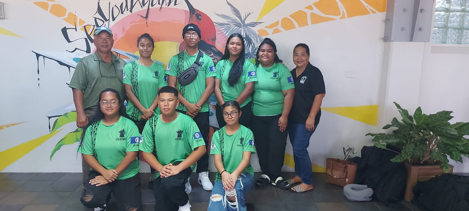 First row, kneeling from left, Julie Mamaril, Jonah Socorro and Chelsea Ayuyu. Second row, retired Sgt. Major Basa, Sadia Rahman, Jolash Saluta, Ashley Villagomez, Nia Amandus, and Ramona Maratita. 