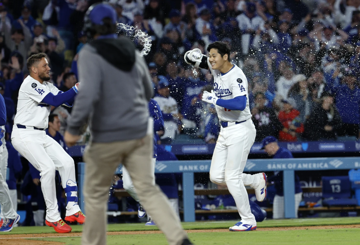 Los Angeles Dodgers Shohei Ohtani, right, is congratulated by Miguel Rojas after a walk-off home run against the Atlanta Braves during the ninth inning of an MLB game Wednesday, April 2, 2025 in Los Angeles.AP
