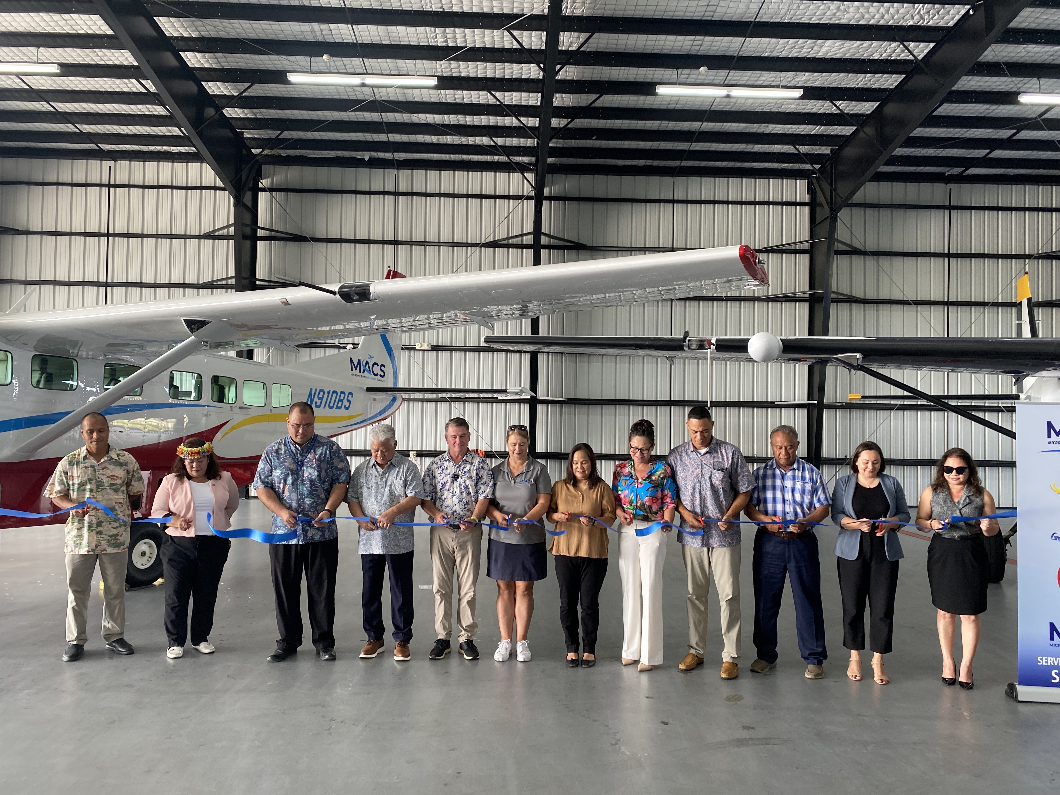 CNMI officials and MACS founders Paula and John Stewart, center, cut the ceremonial ribbon to start the air service to Rota at MACS’ As Lito hangar.