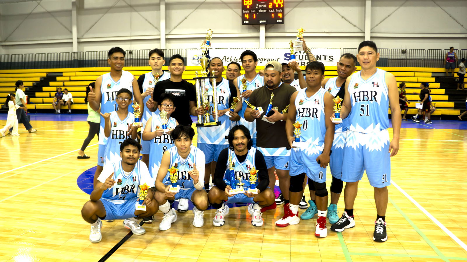 HBR Construction players pose with the championship trophy during the awards ceremony of the Alpha Kappa Rho 1st Semi-Open Invitational Basketball League 2025 at the Gilbert C. Ada Gymnasium on Sunday night.Contributed photo